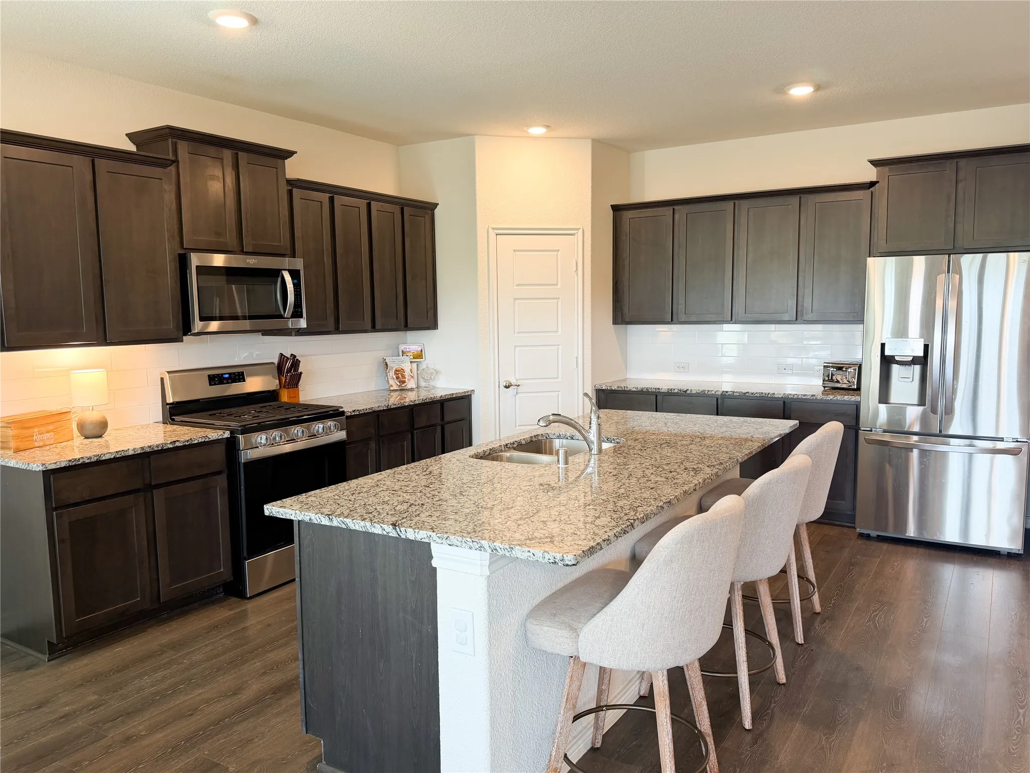 Kitchen Island with Four Comfy Bar Stools Will Easily Acomodate Four Normal Sized Bar Stools