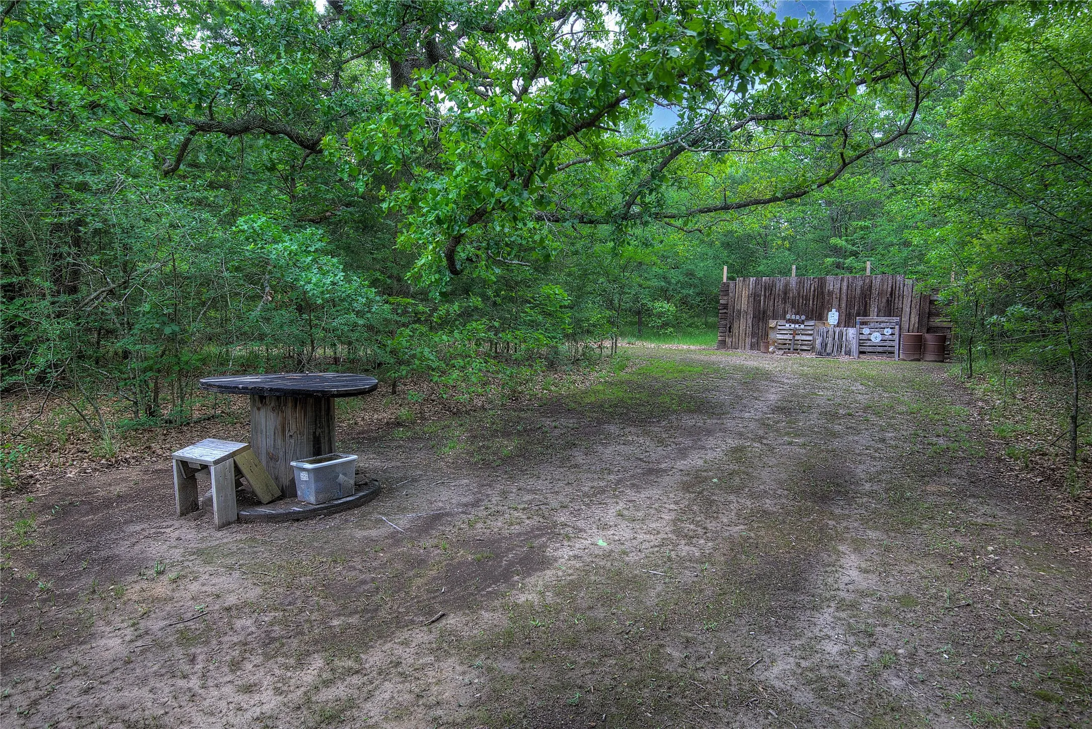 Single lane shooting range with backstop and tables