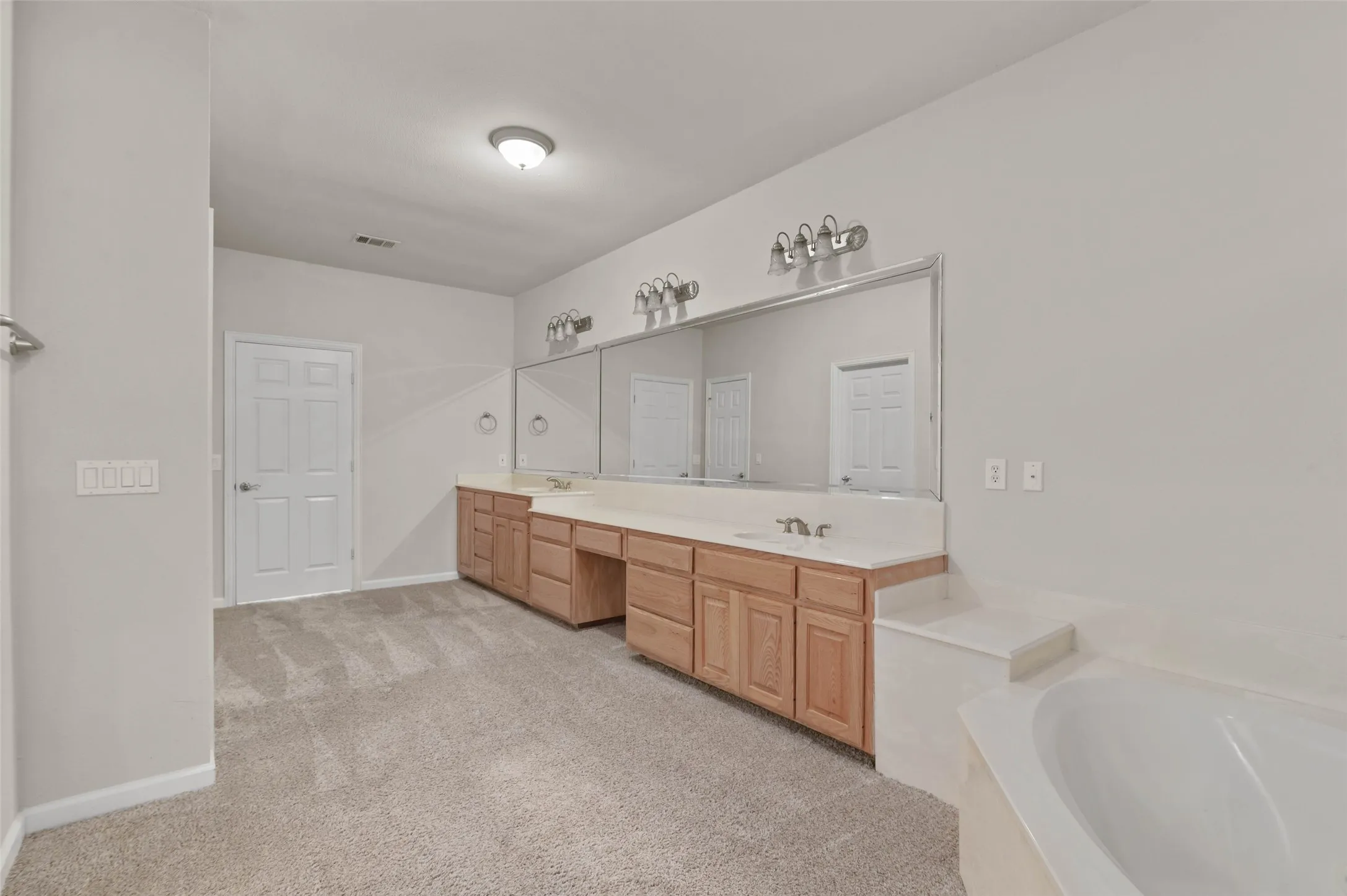Huge primary bathroom with garden tub and separate shower.