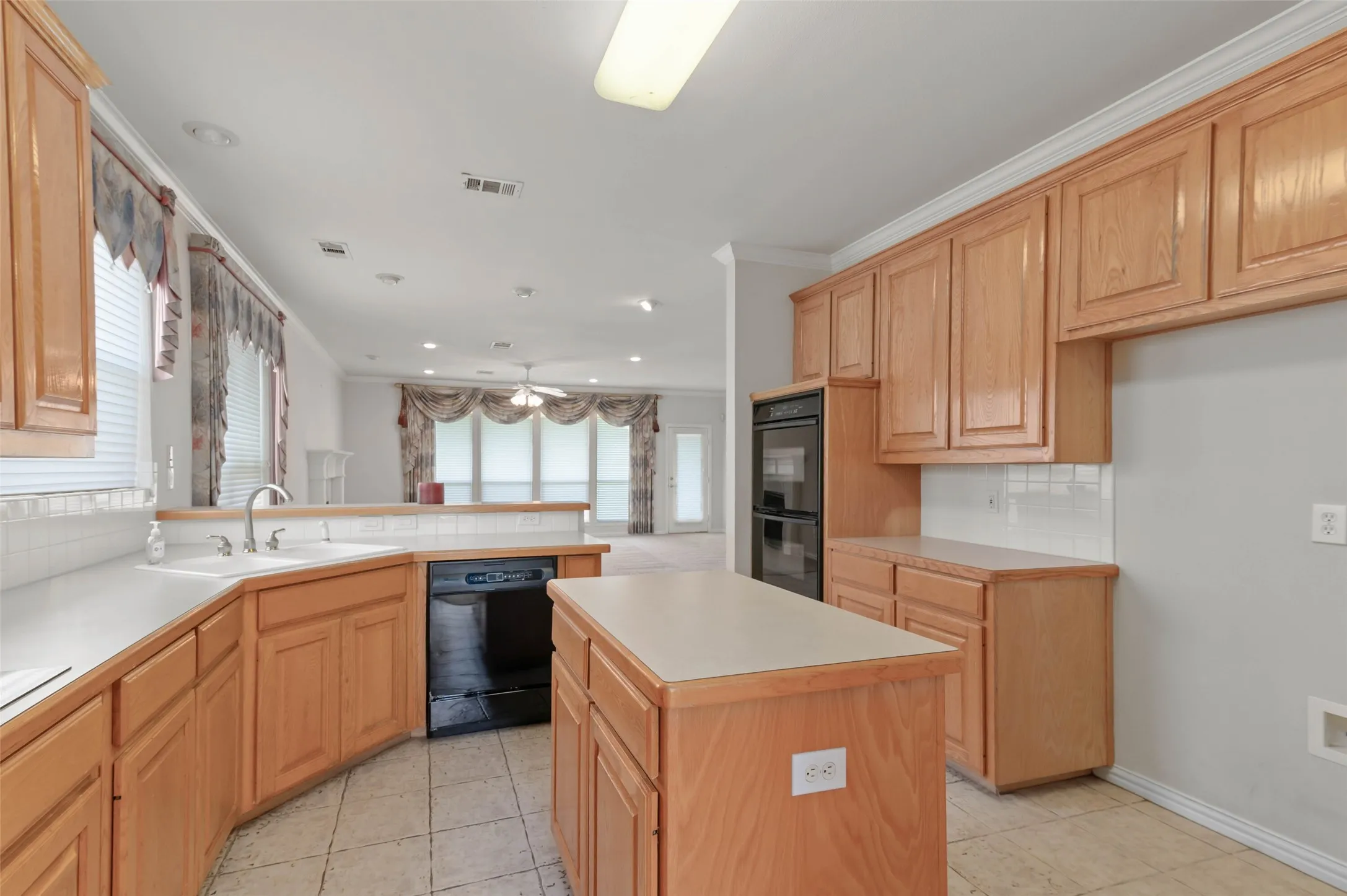 Kitchen with tile flooring, kitchen Island and a huge amount of counter and storage space.