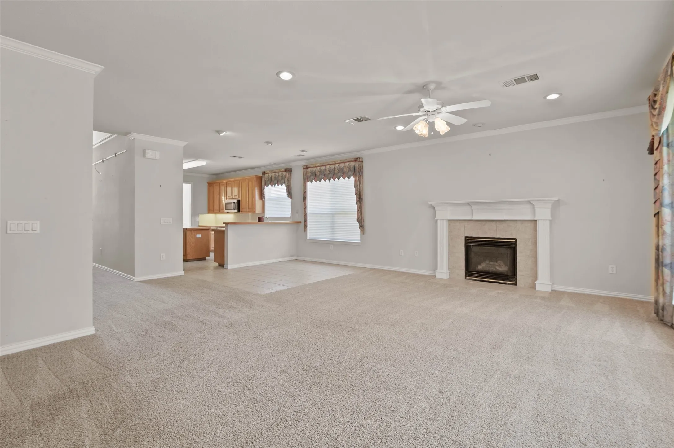 View from the back door into the spacious living area with fireplace.