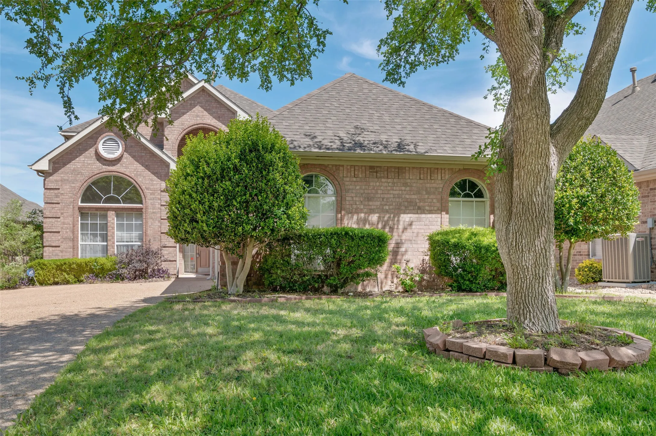 View of the front of this beautiful brick home on the golf course in a gated community.