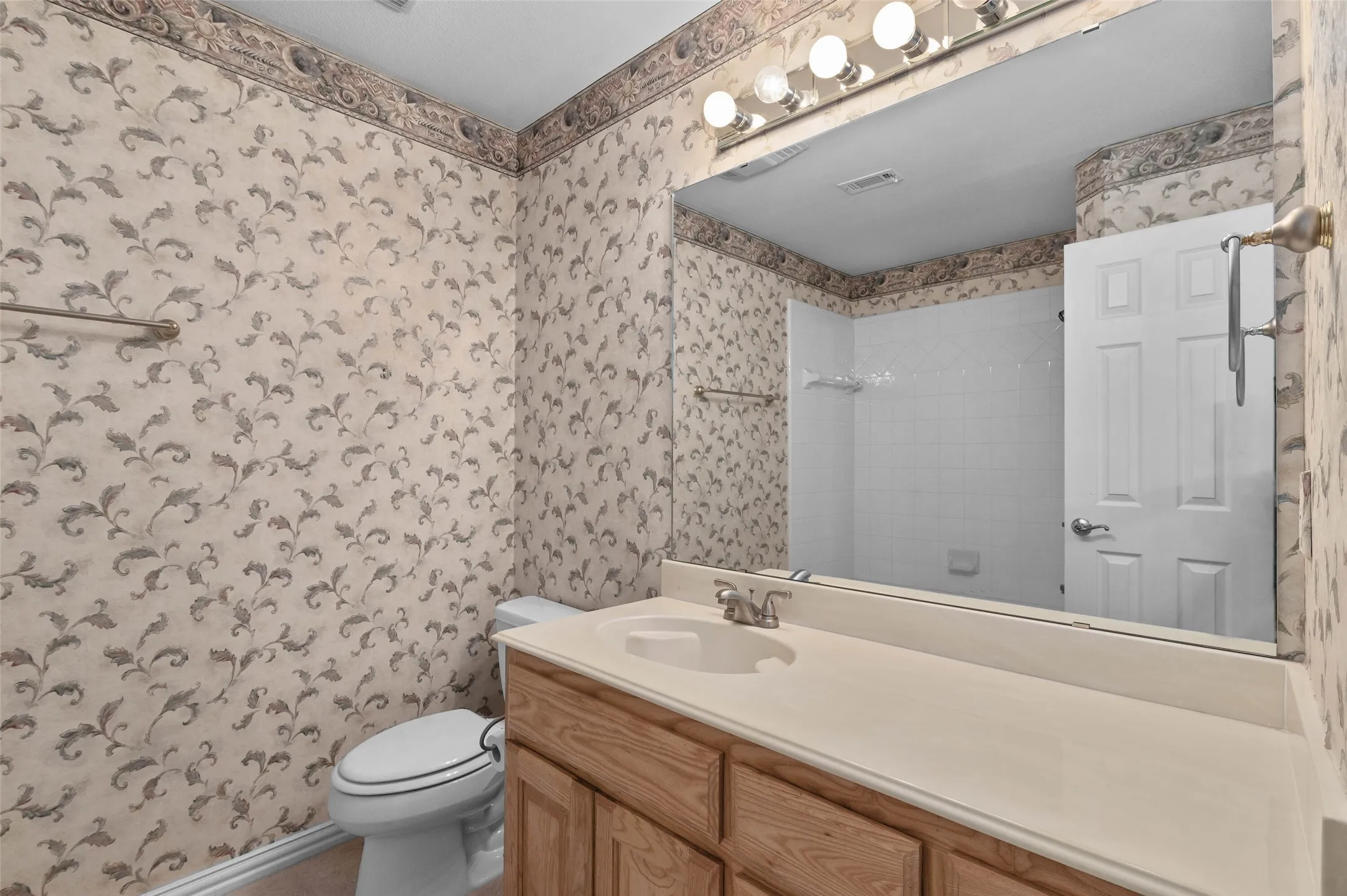 Upstairs bathroom with a tub/shower combination and a large vanity with plenty of counter space.