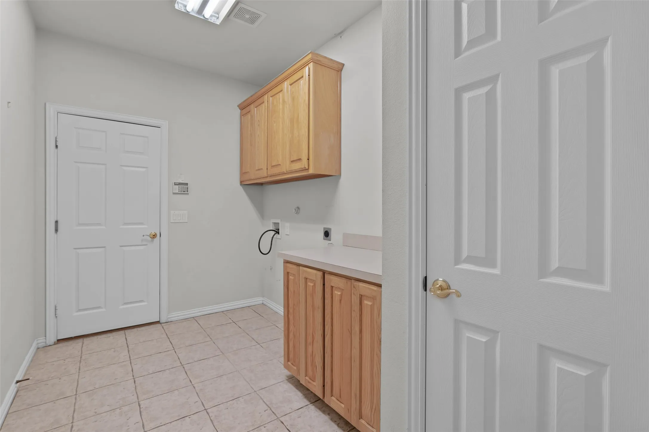 Large laundry room with full size W/D hookup and built-in cabinets.