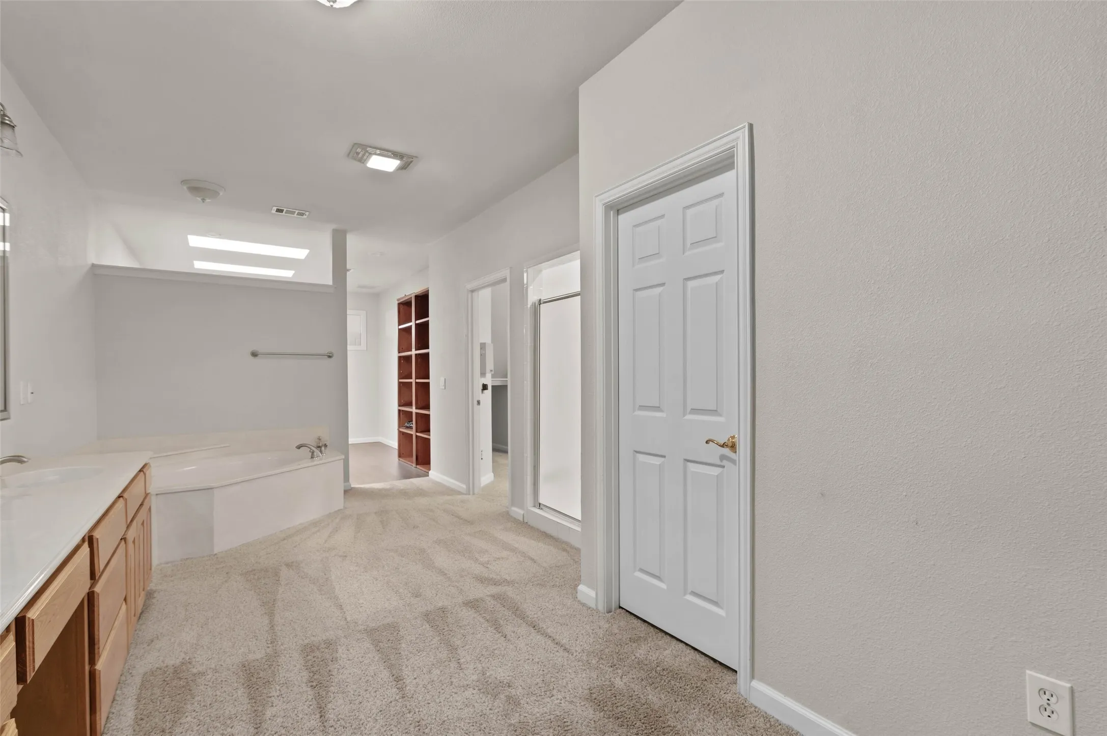 Huge primary bathroom with garden tub and separate shower.