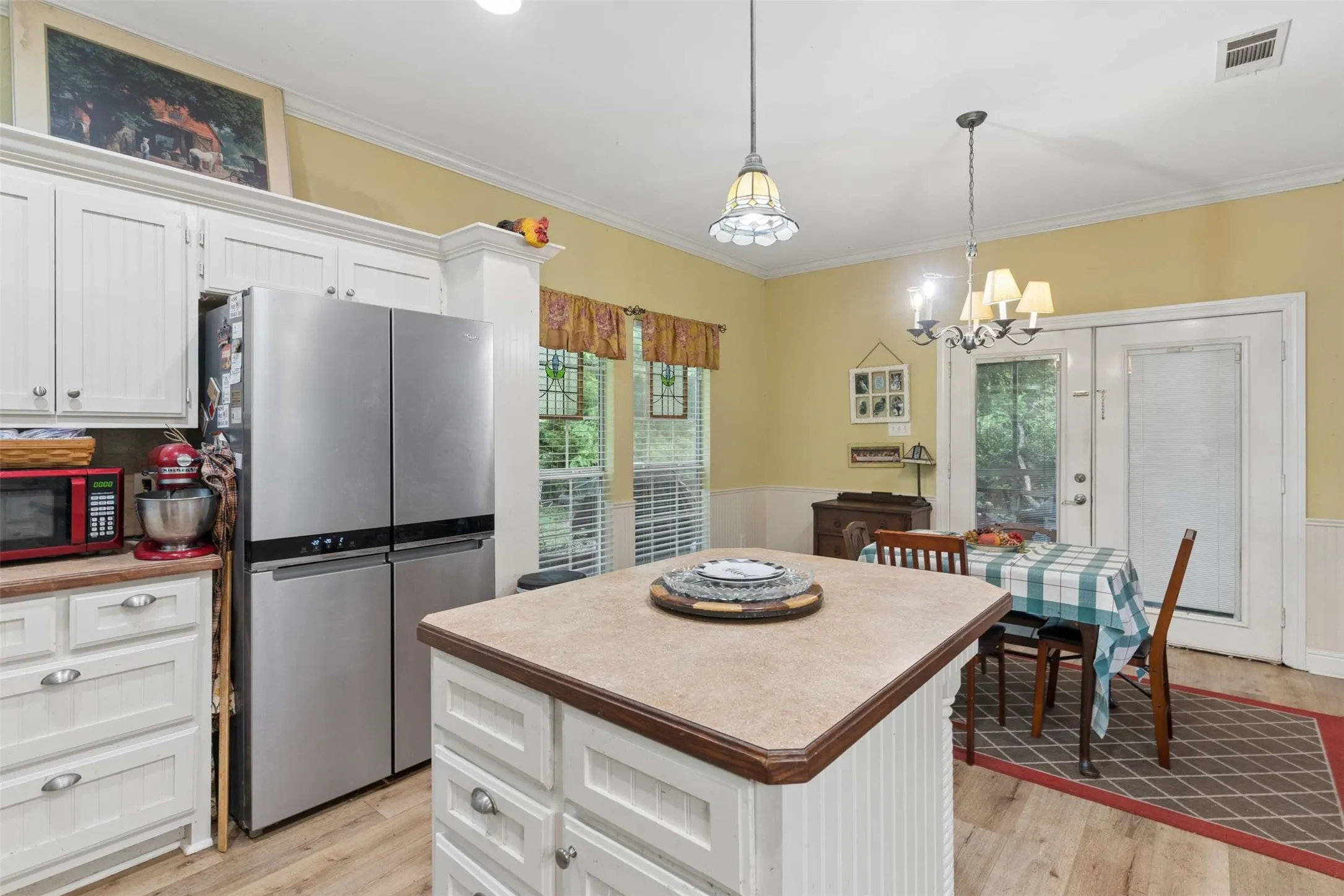 Spacious living area featuring a vaulted ceiling with exposed wood beams, recessed lighting, and a ceiling fan