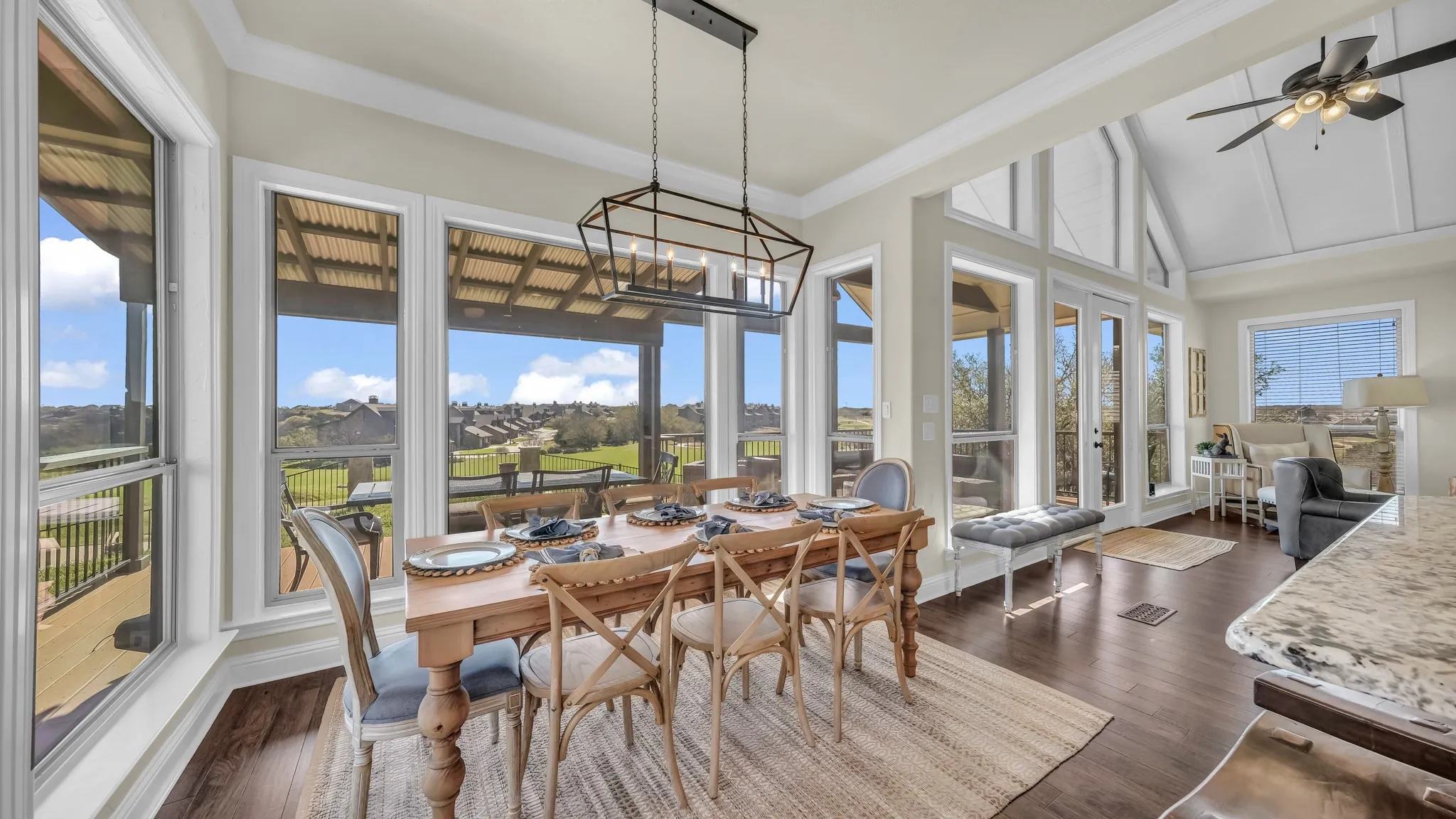 Copious amounts of natural light and gorgeous views are enjoyed from all areas of this living, dining, and kitchen area.