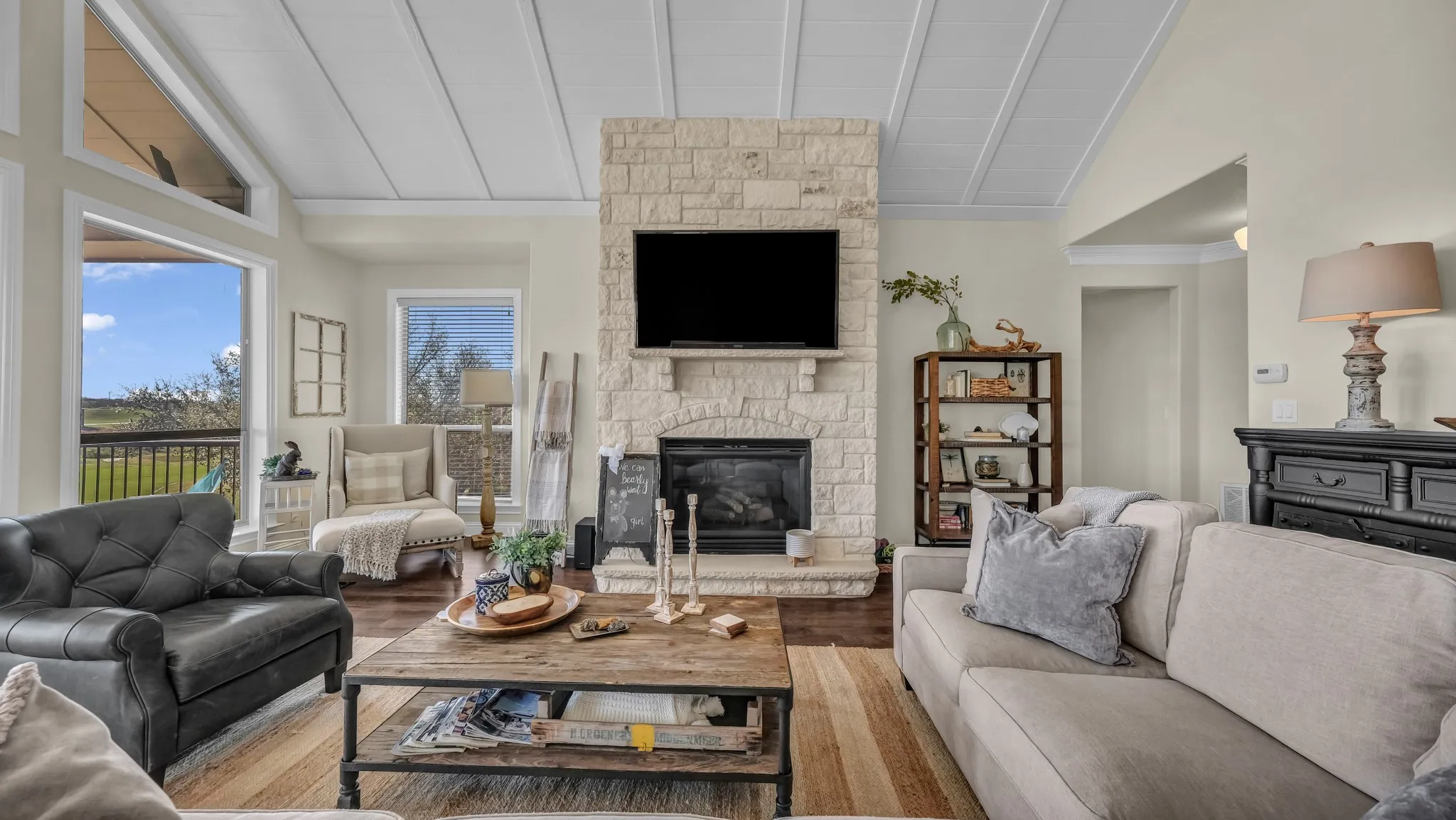 Elegant stone hearth is powered by gas logs.  This adds warmth and charm to an already amazing gathering spot!
