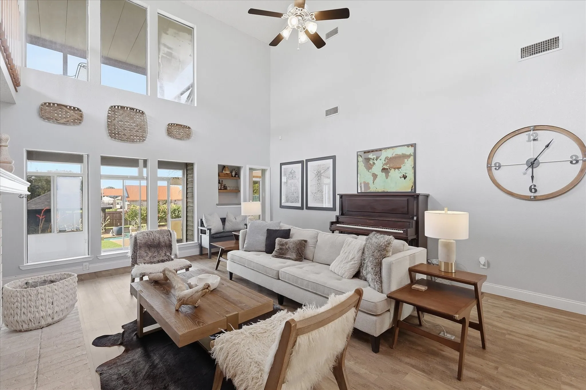 Large living room with high ceilings, flooded by natural light. Views of the one-of-a-kind backyard.
