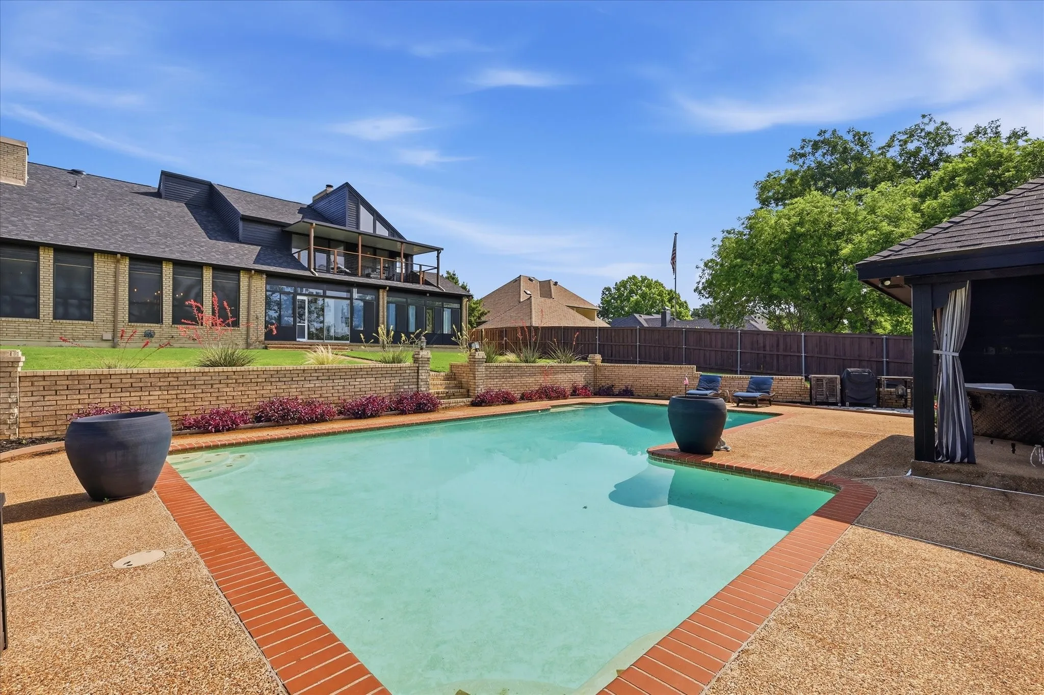 Large in-ground pool with large deck and poolside cabana.