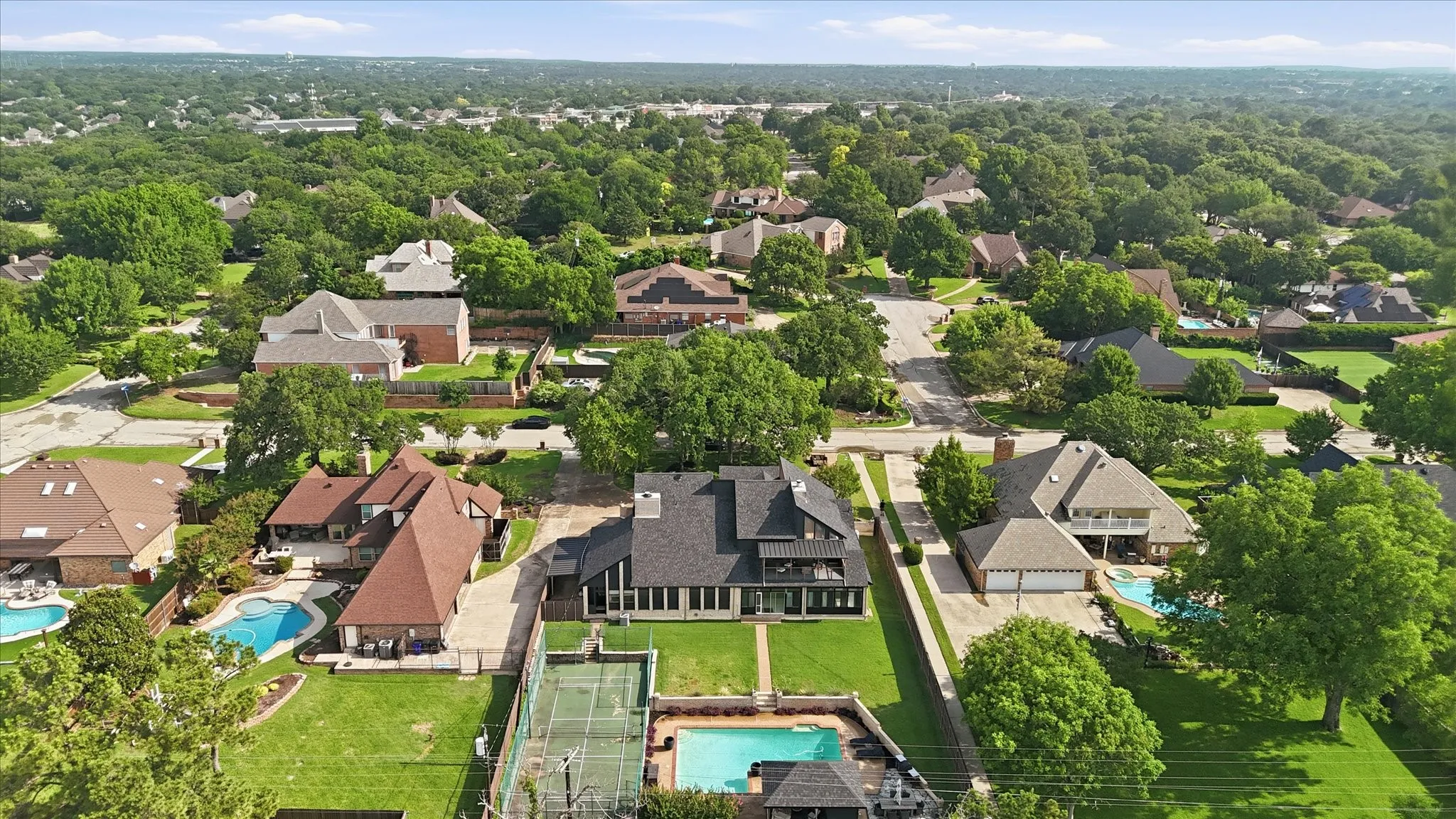 Expansive property featuring a private sports court, swimming pool, and dedicated pool cabana