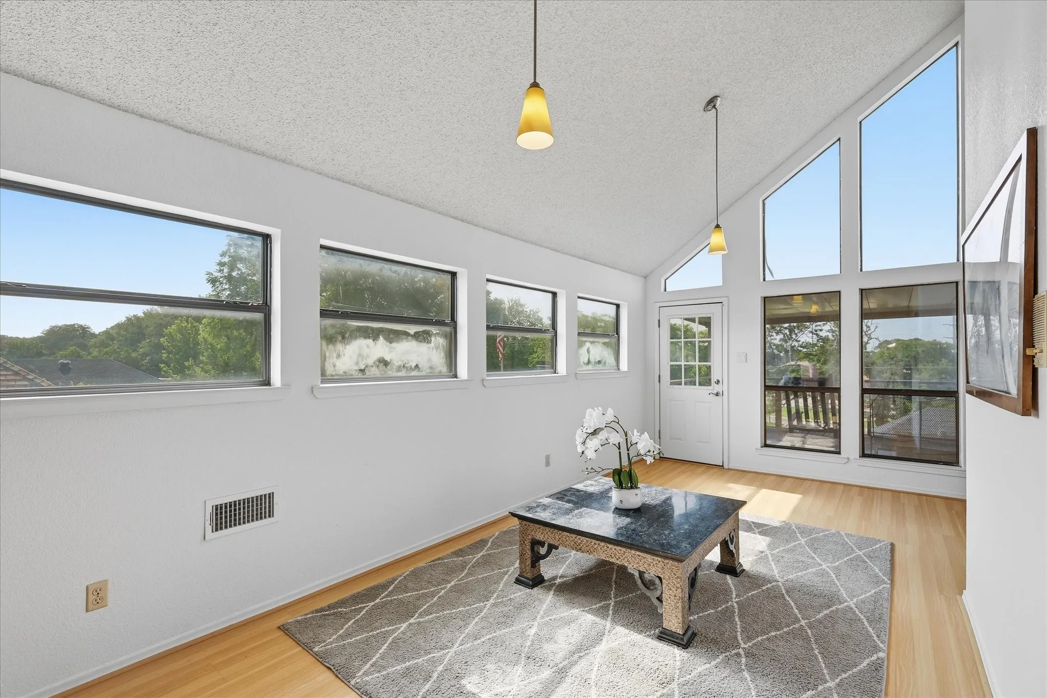 Upstairs loft area with lots of windows and access to the balcony that overlooks the backyard.