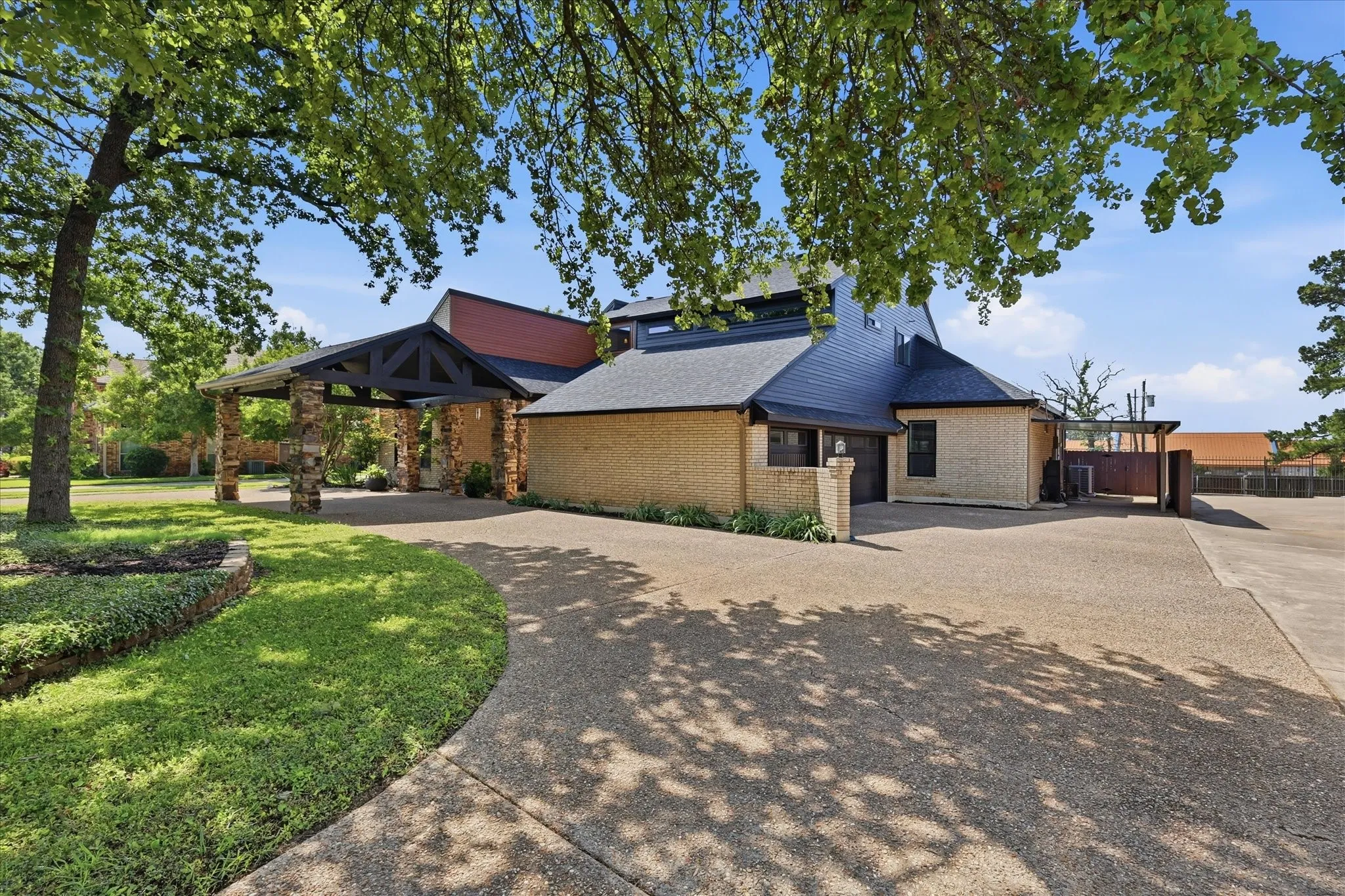 Circular driveway, three car garage, carport and separate port cochere, mature trees and lush, manicured lawn