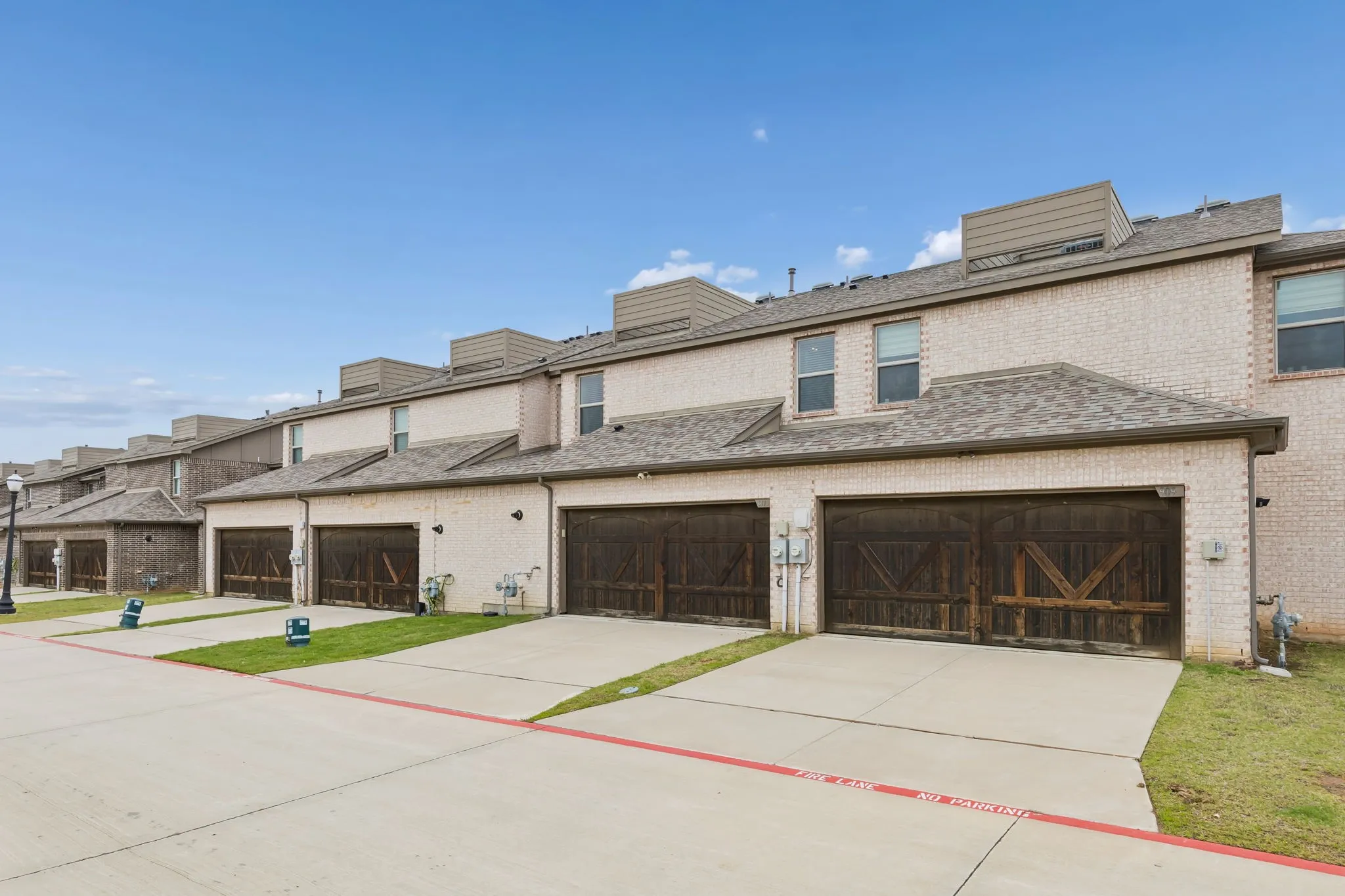 Rear Entry garage with wood-look door, concrete driveway