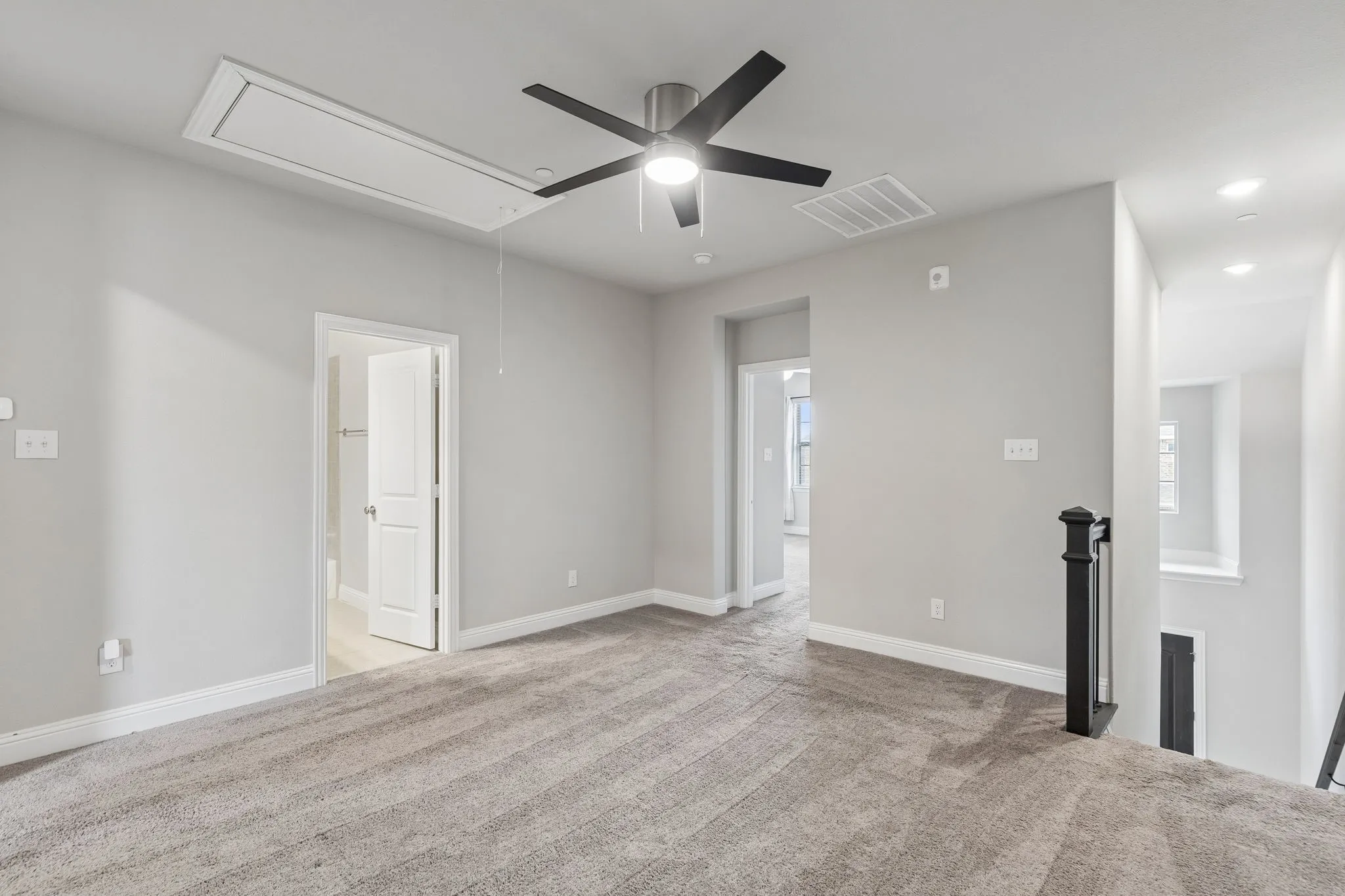 Carpeted room with light gray walls, a modern ceiling fan, recessed lighting, and a white access panel