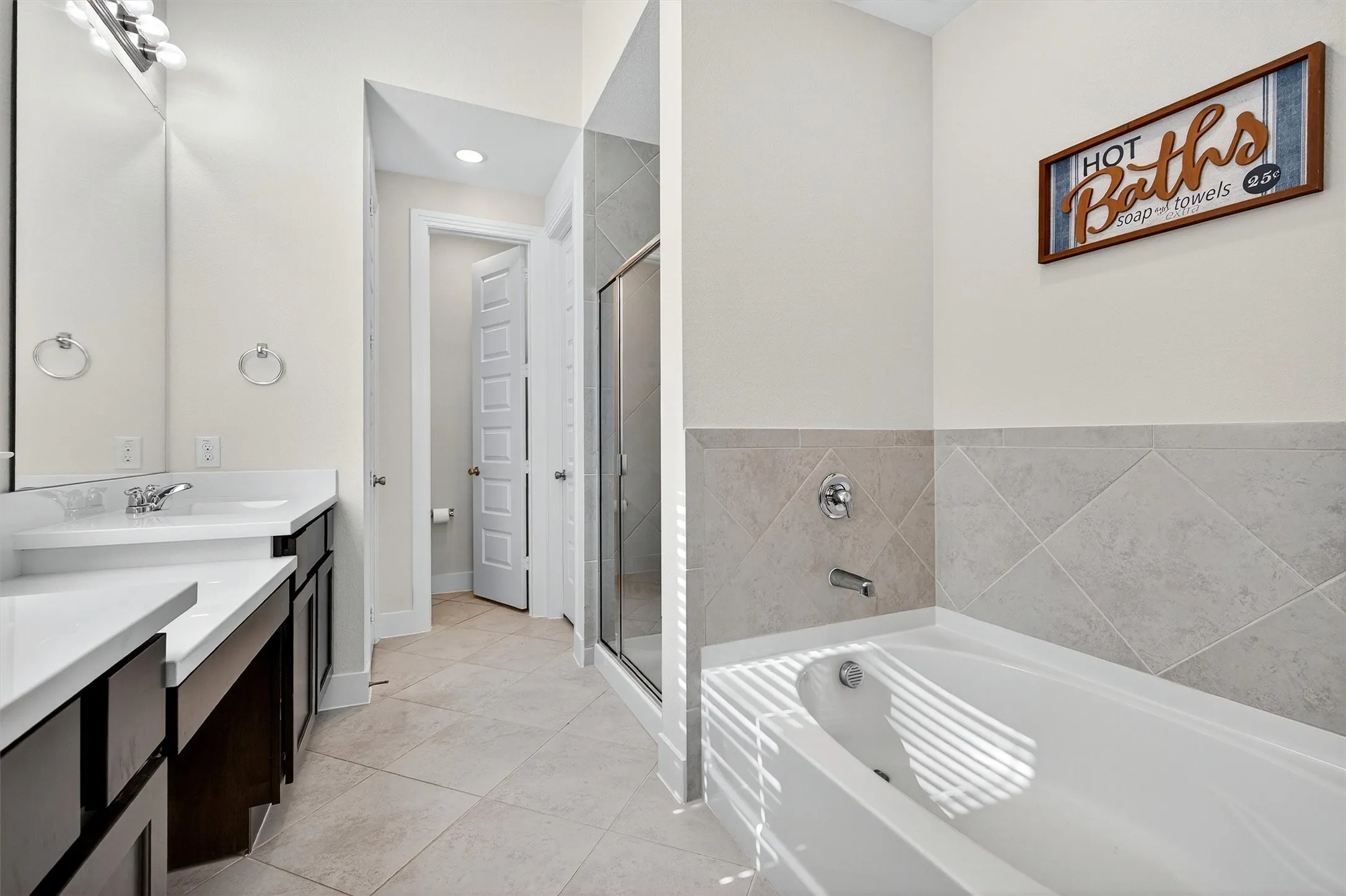 Full bathroom featuring vanity, a garden tub, light tile patterned flooring, a shower stall, and recessed lighting