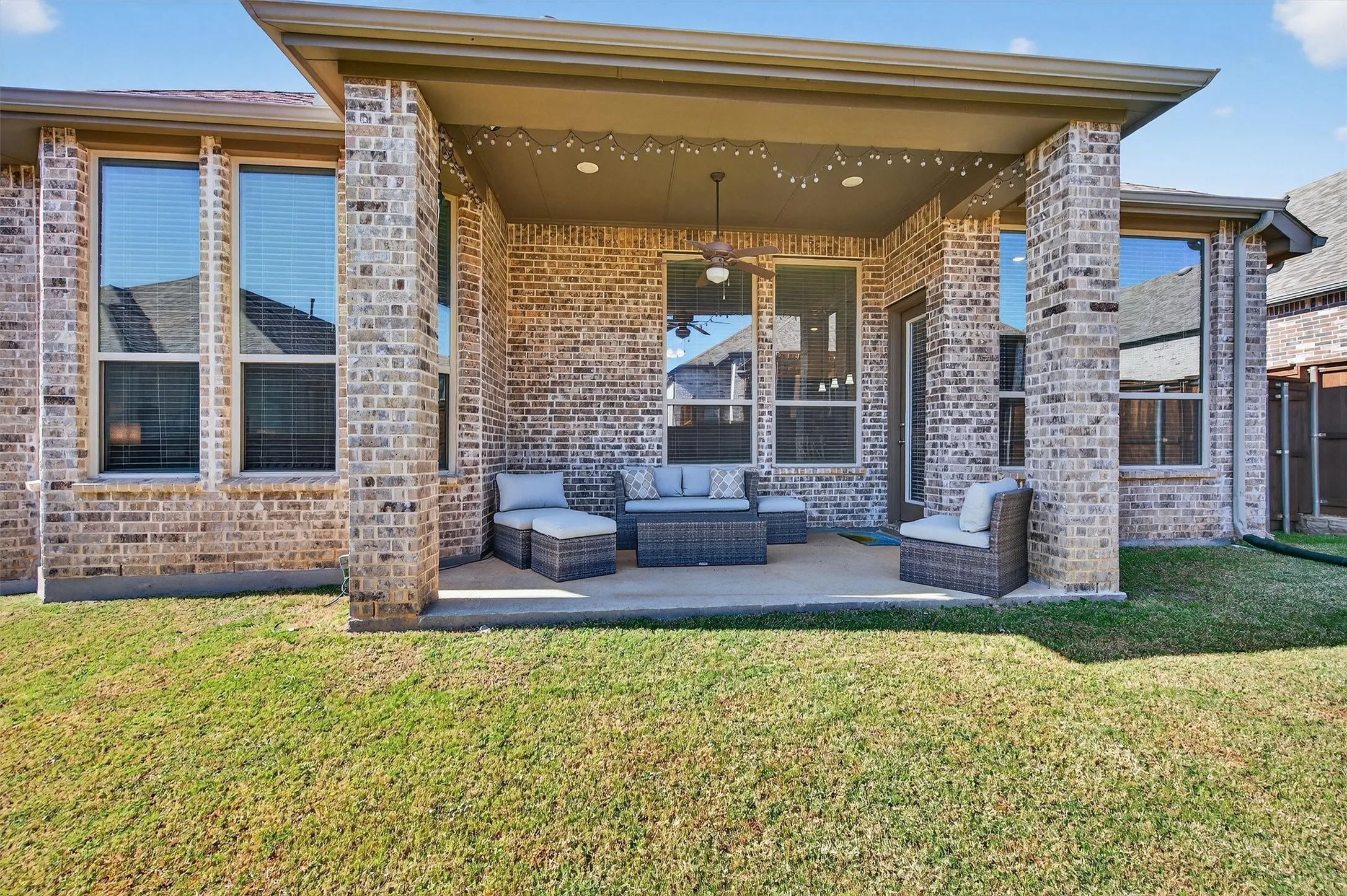 View of patio with ceiling fan and an outdoor hangout area