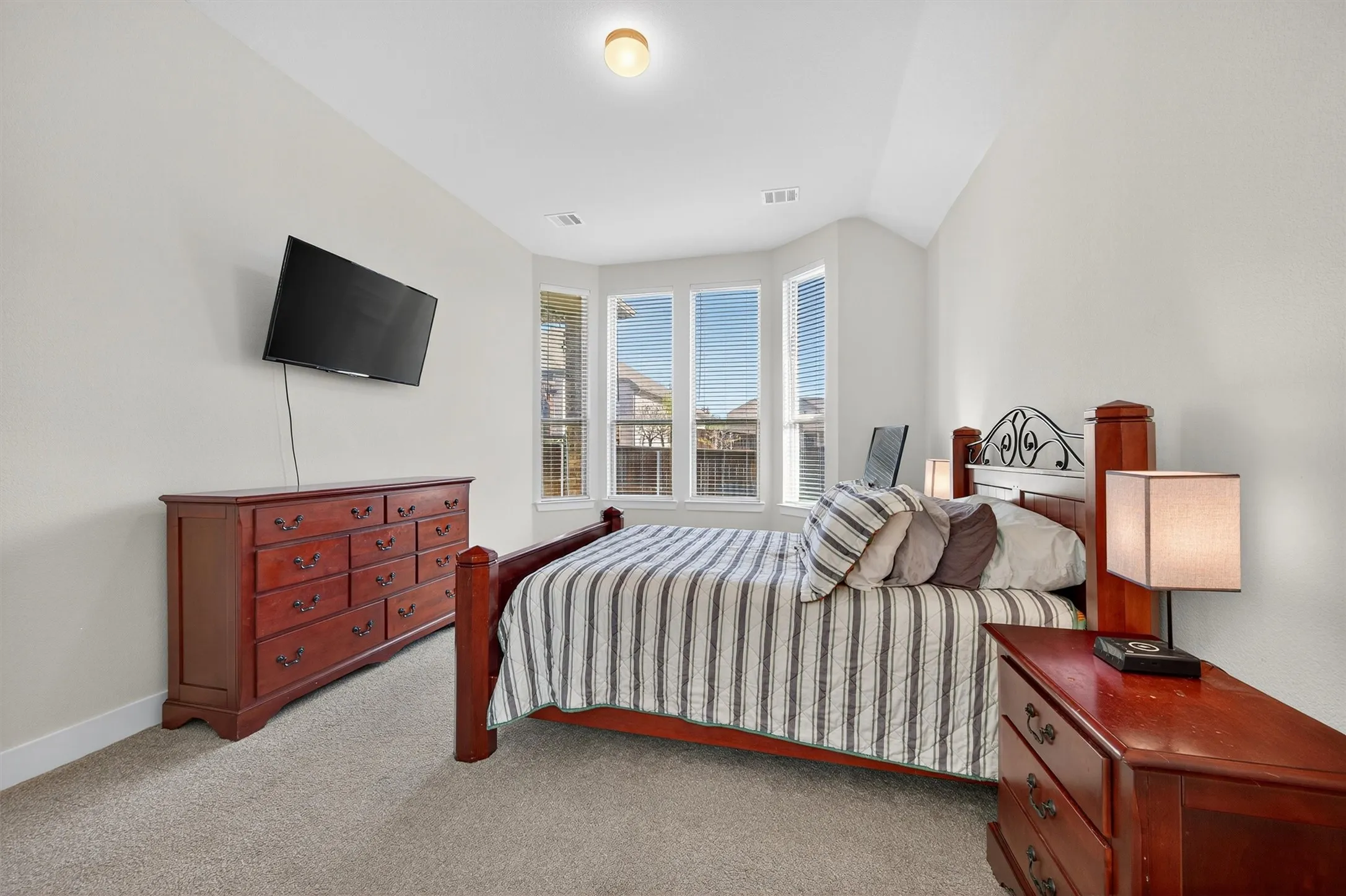 Bedroom featuring light colored carpet and baseboards