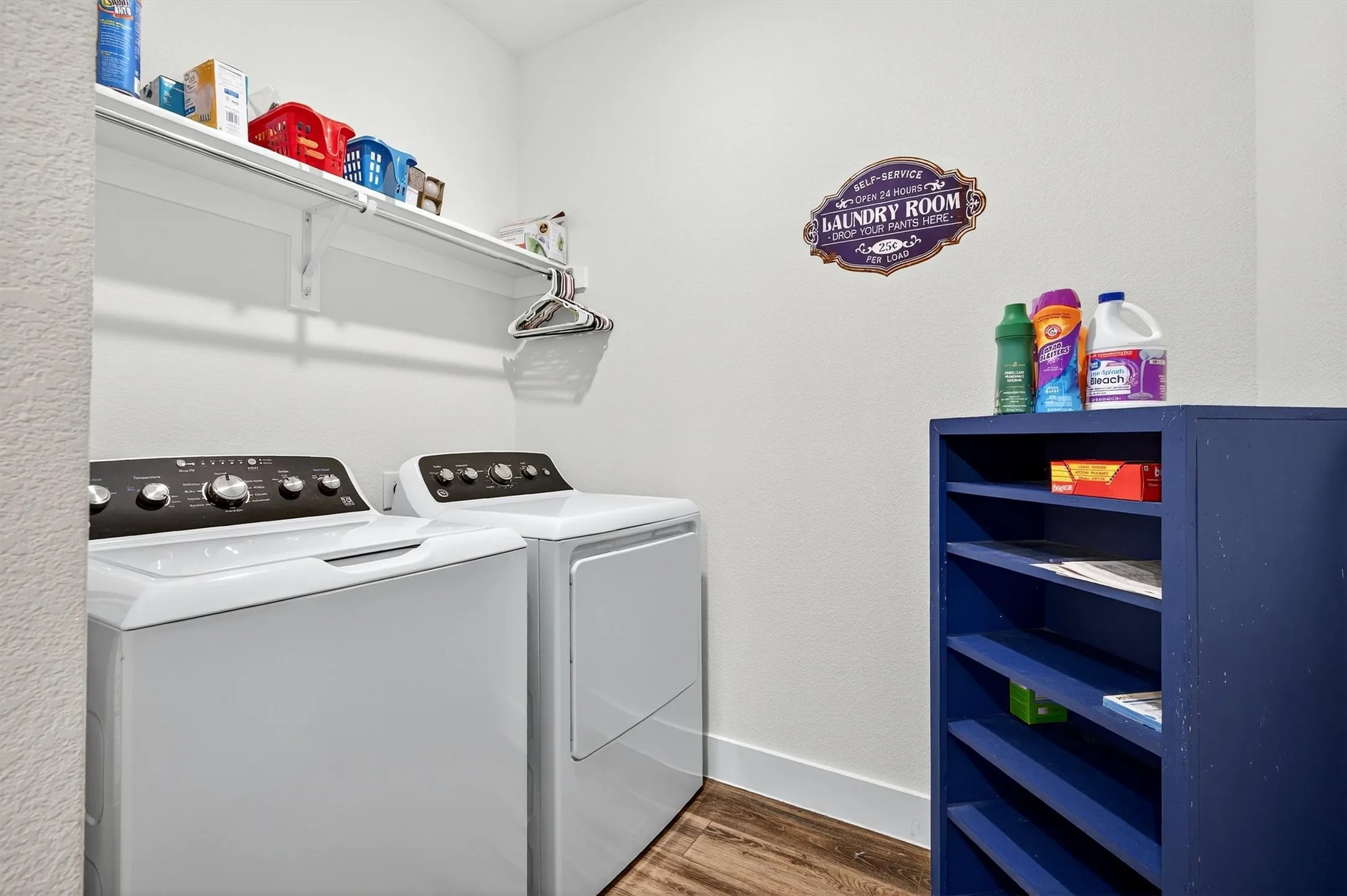 Laundry area with dark wood-type flooring and independent washer and dryer