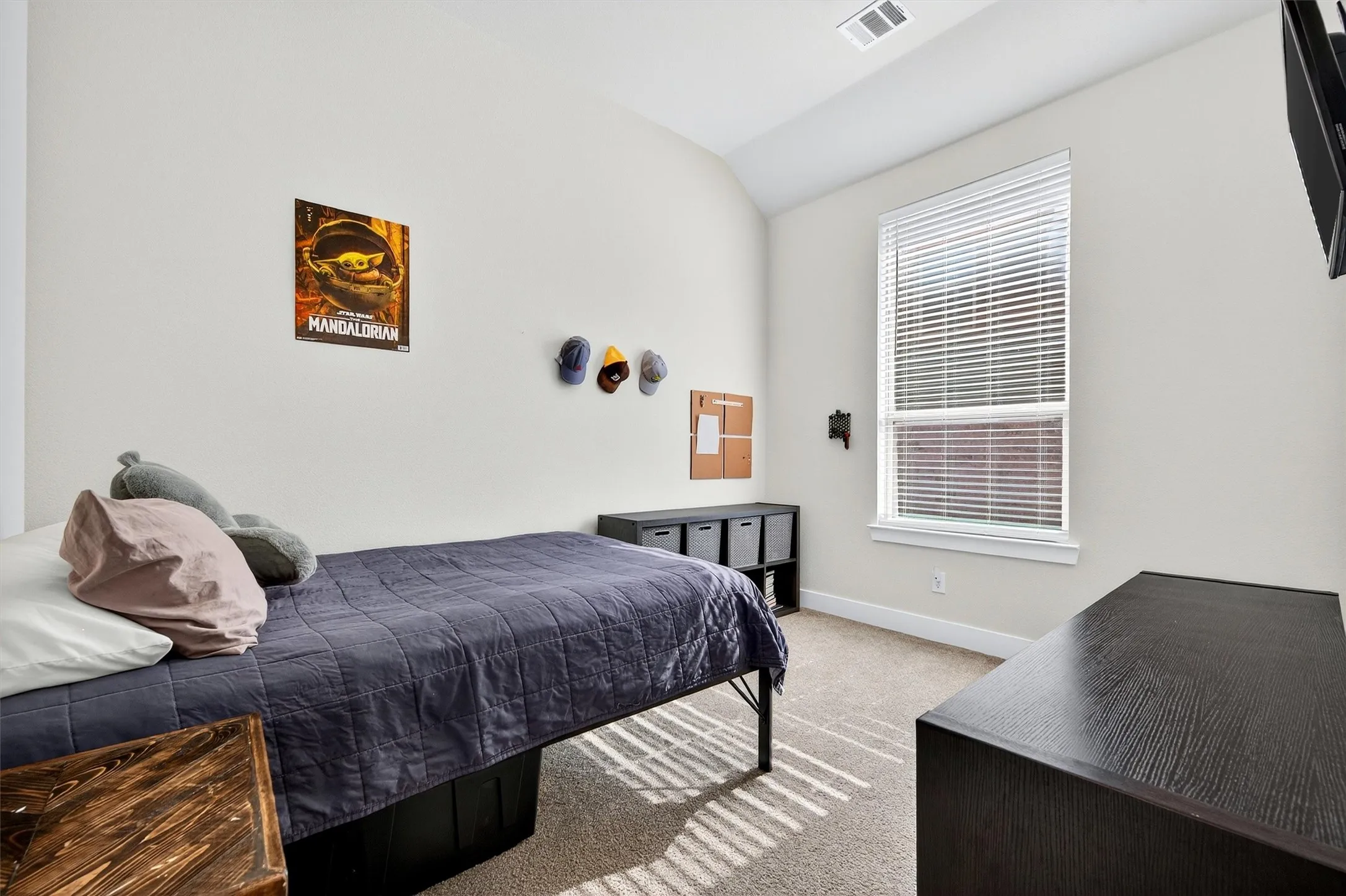 Bedroom featuring light carpet and lofted ceiling