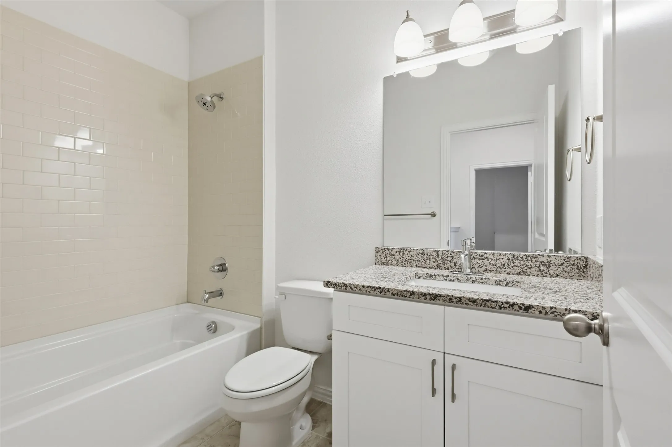 Guest bathroom upstairs with granite countertop and shower/tub combo