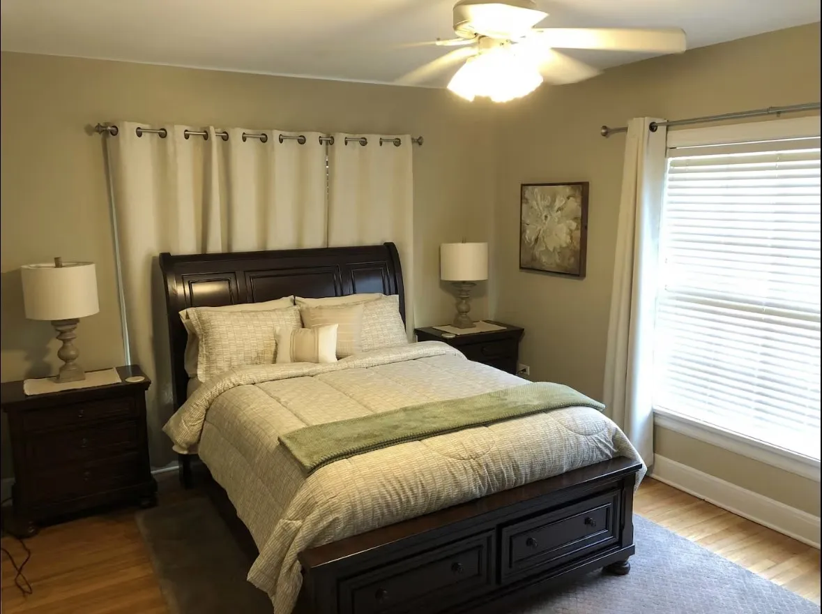 Hardwood-style flooring with a soft area rug. Second bedroom.