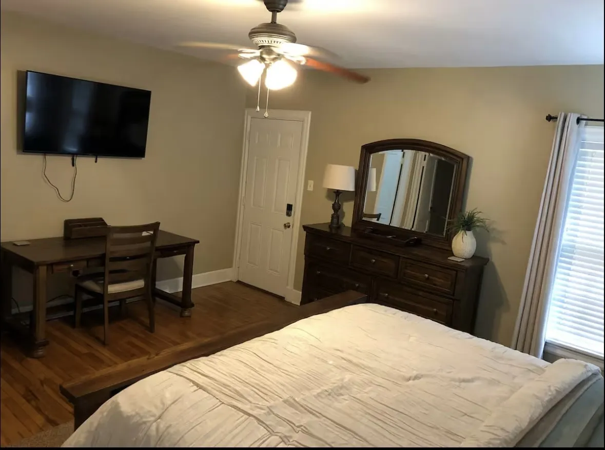 Neutral wall tones complement wood-finish flooring