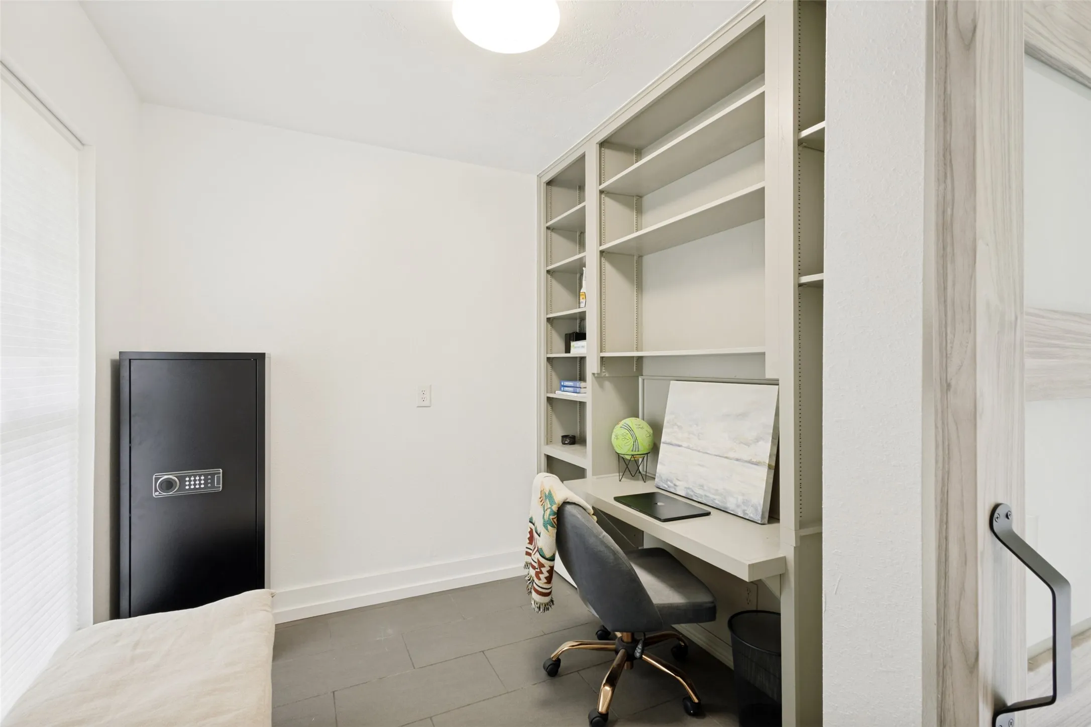 Built-in shelving and desk unit with a light neutral finish