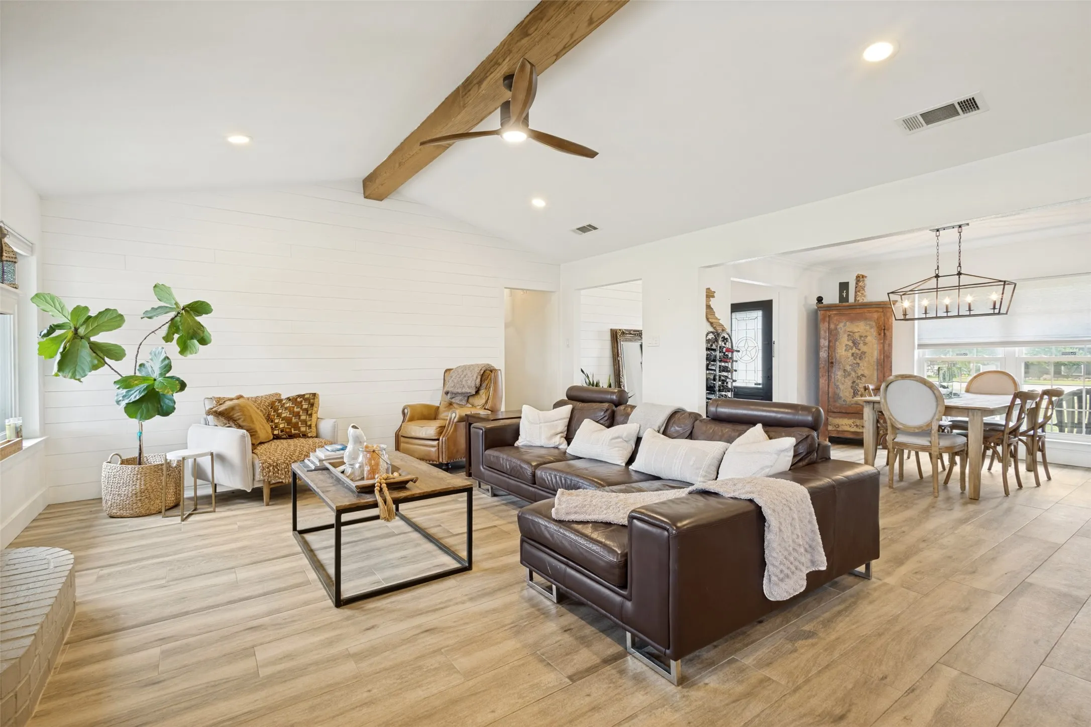 Vaulted ceiling with exposed wood beam and ceiling fan