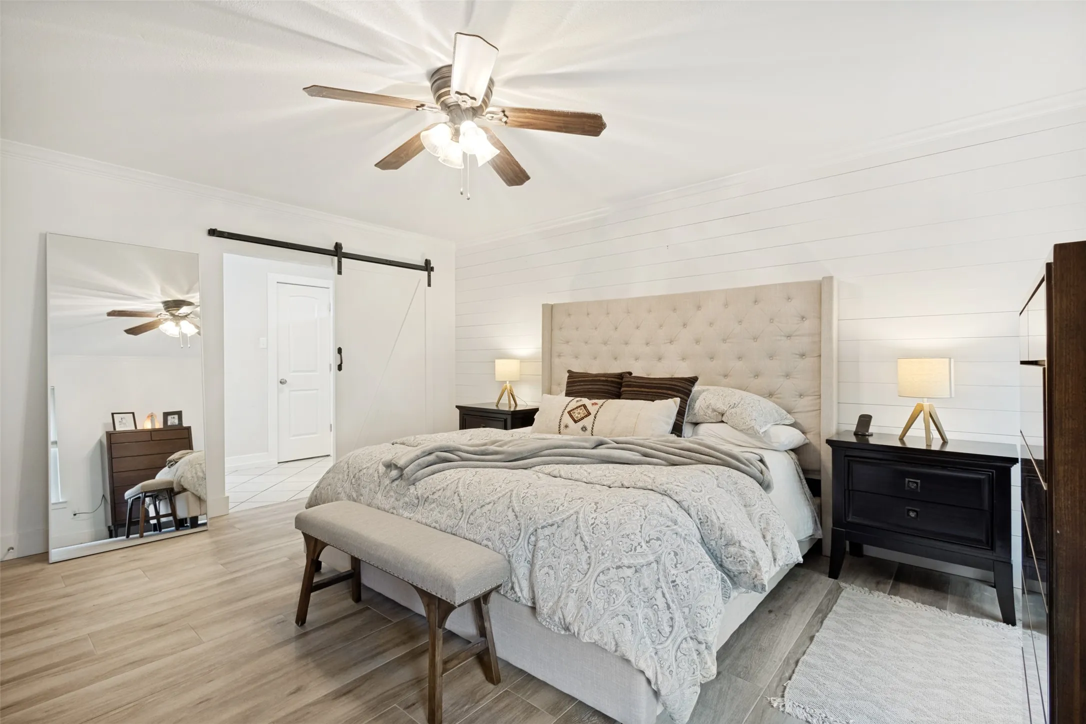 Spacious room featuring wood-finish flooring and a ceiling fan
