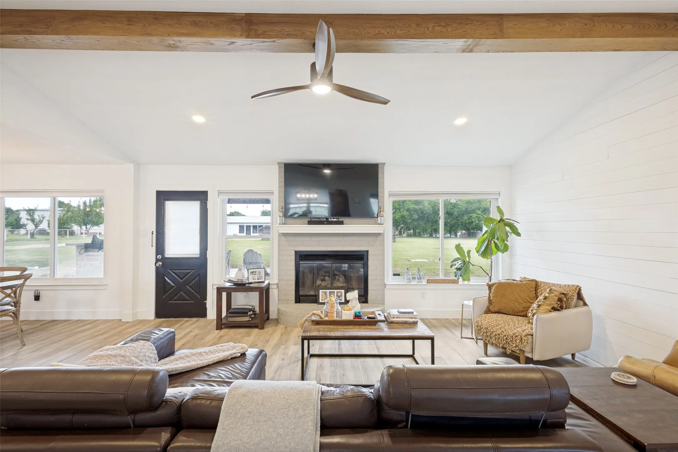 Vaulted ceiling with exposed wood beams and recessed lighting