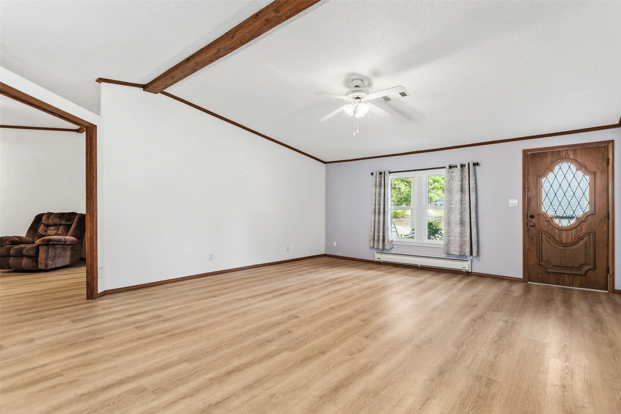 Entry door to the right with large family room and private den to the left with fireplace