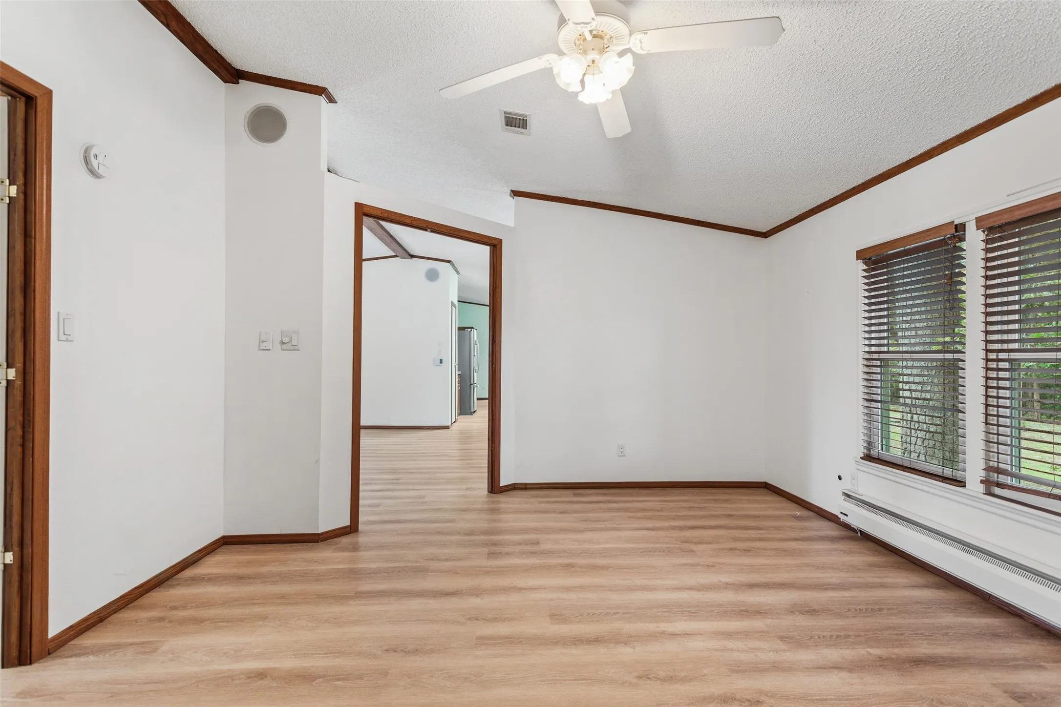 Coming out of Primary Bedroom Leading to Main Living Area Dining and Kitchen