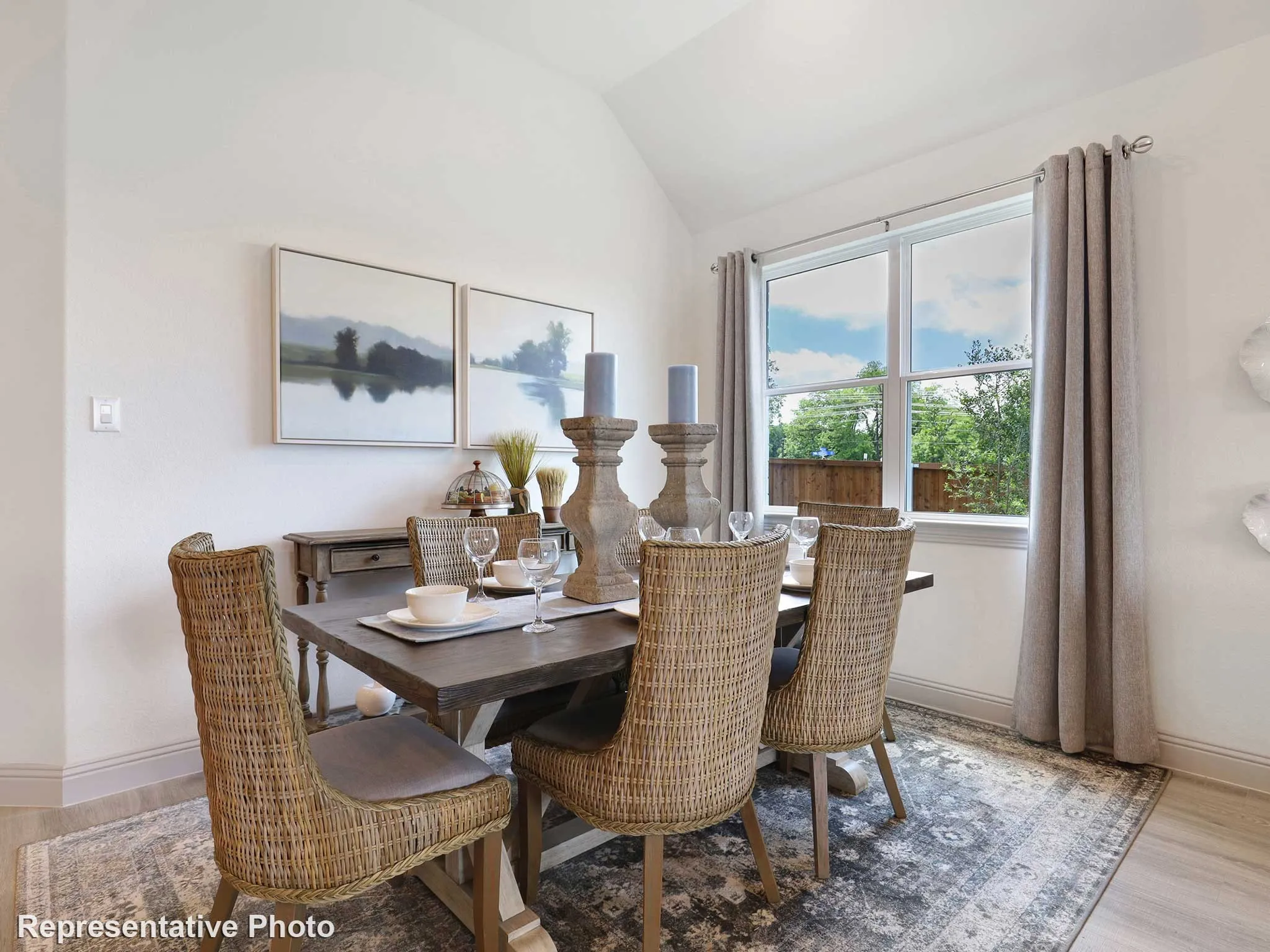 Dining area featuring a vaulted ceiling and window with outdoor scenery
