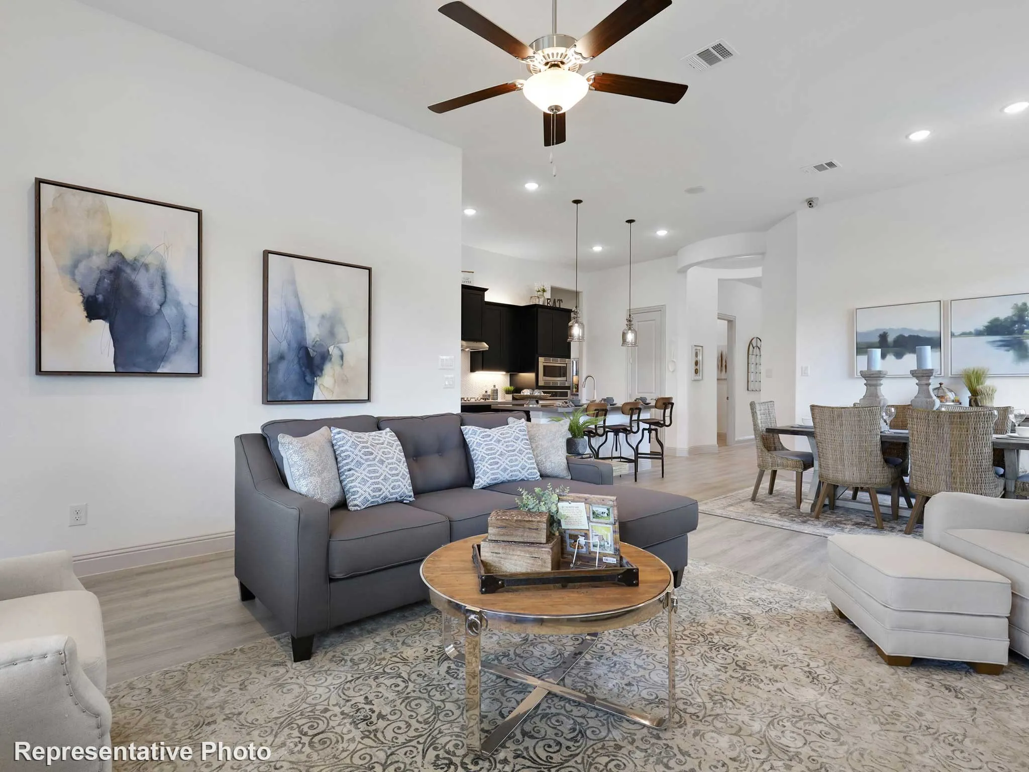 Open-concept living space featuring wood-finish flooring, recessed lighting, and a ceiling fan