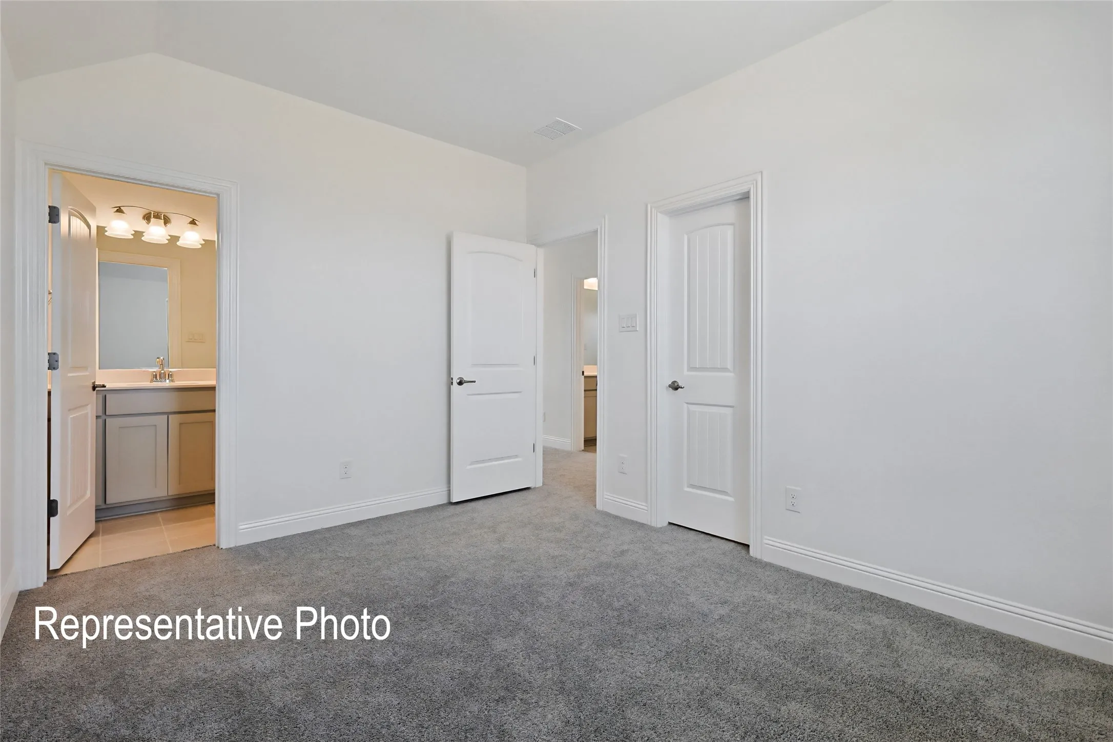 Bedroom with plush gray carpeting, white walls, and white trim