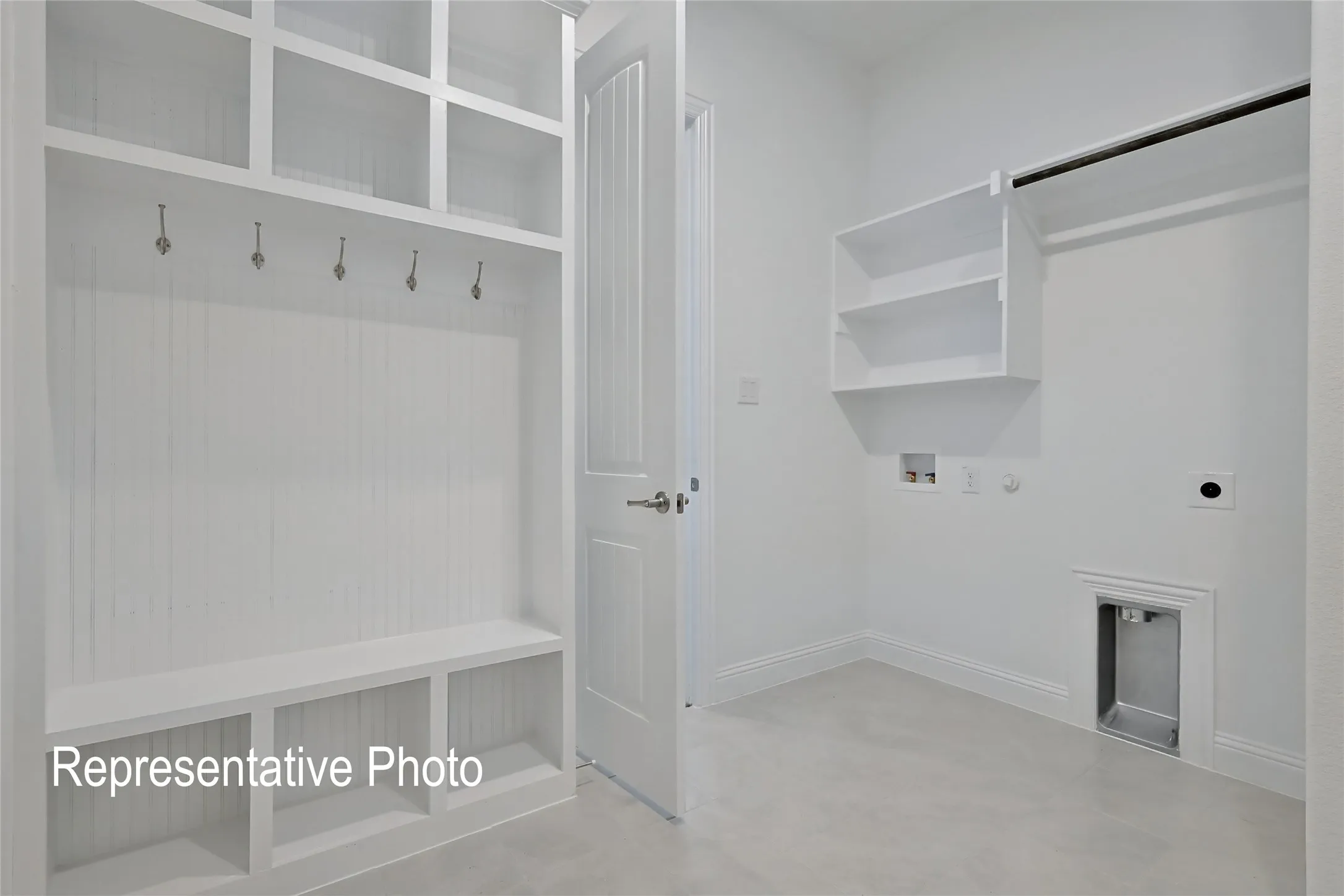 Utility space featuring a built-in mudroom bench with cubbies, overhead shelving, and wall hooks