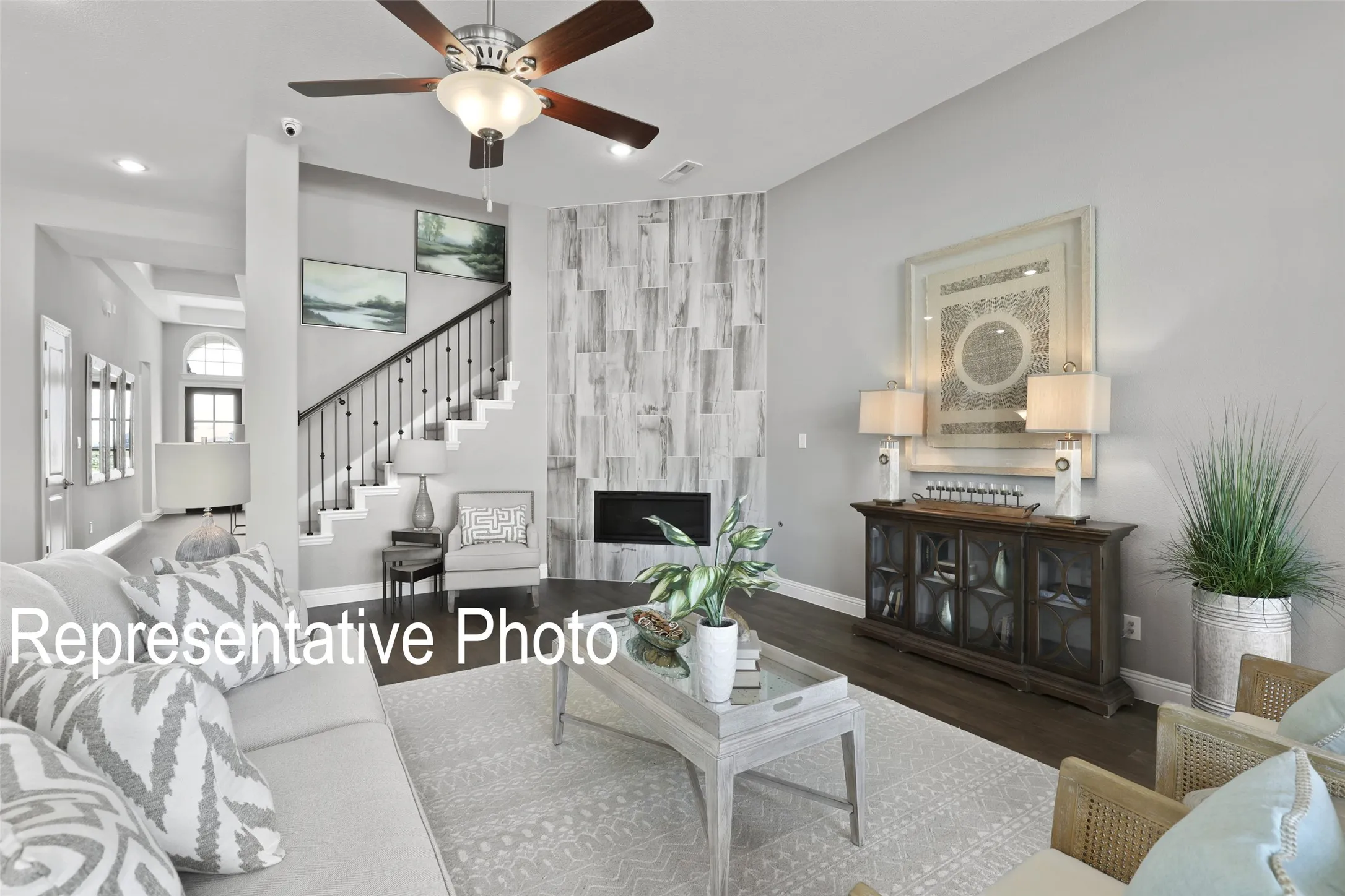 Living area featuring dark wood-finish flooring and a light-toned area rug