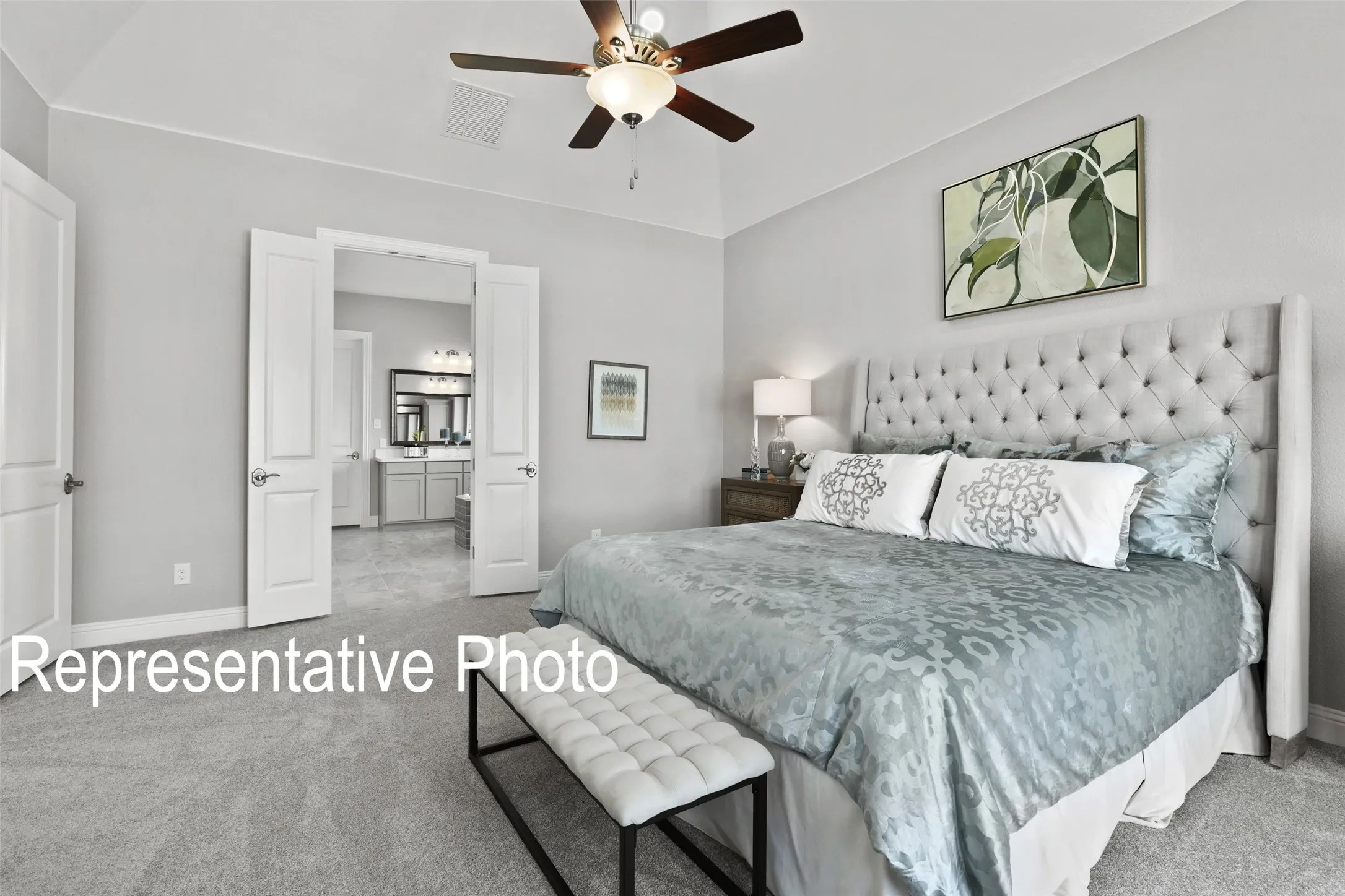 Carpeted room with vaulted ceiling and a ceiling fan