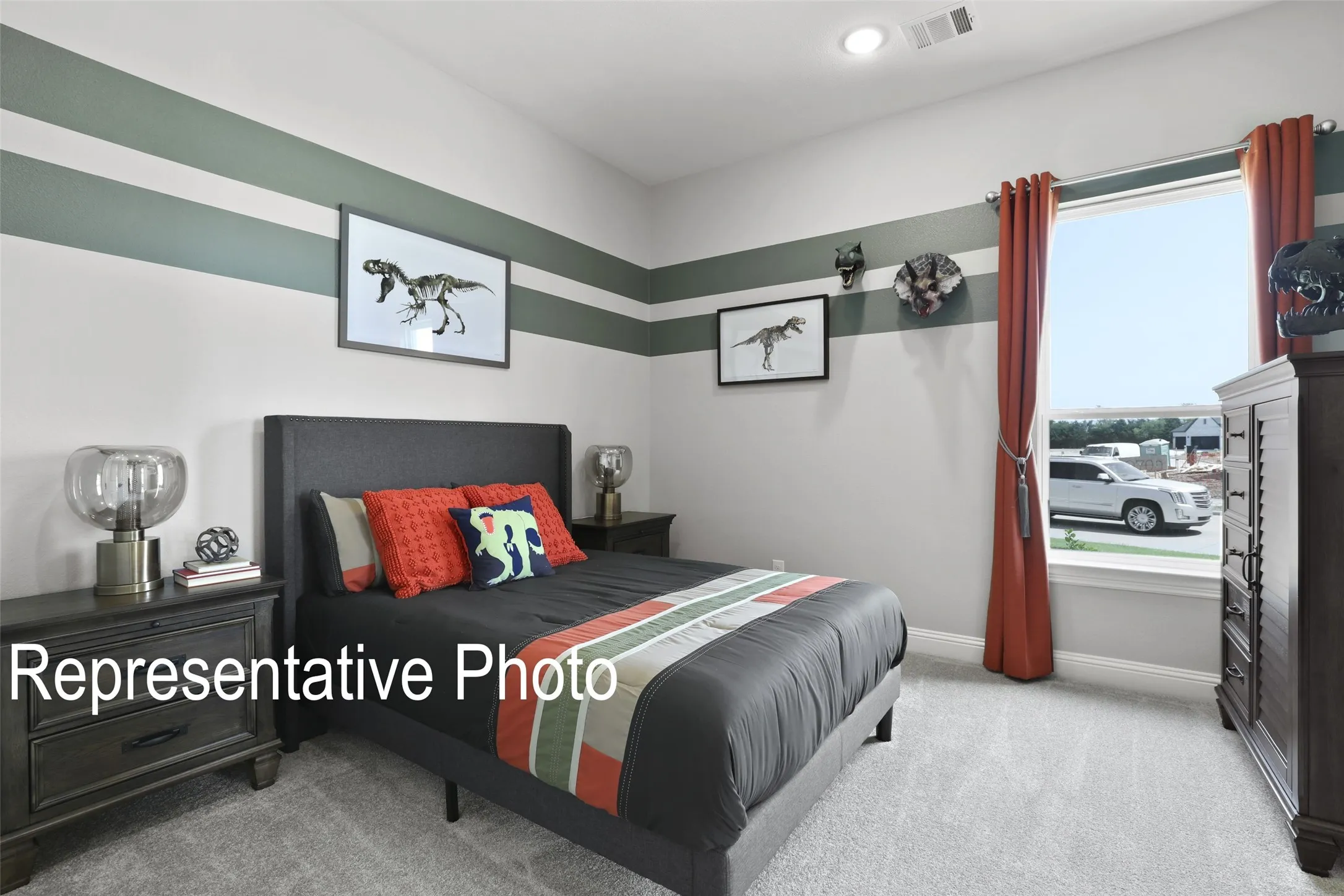 Carpeted bedroom with a window featuring red drapery