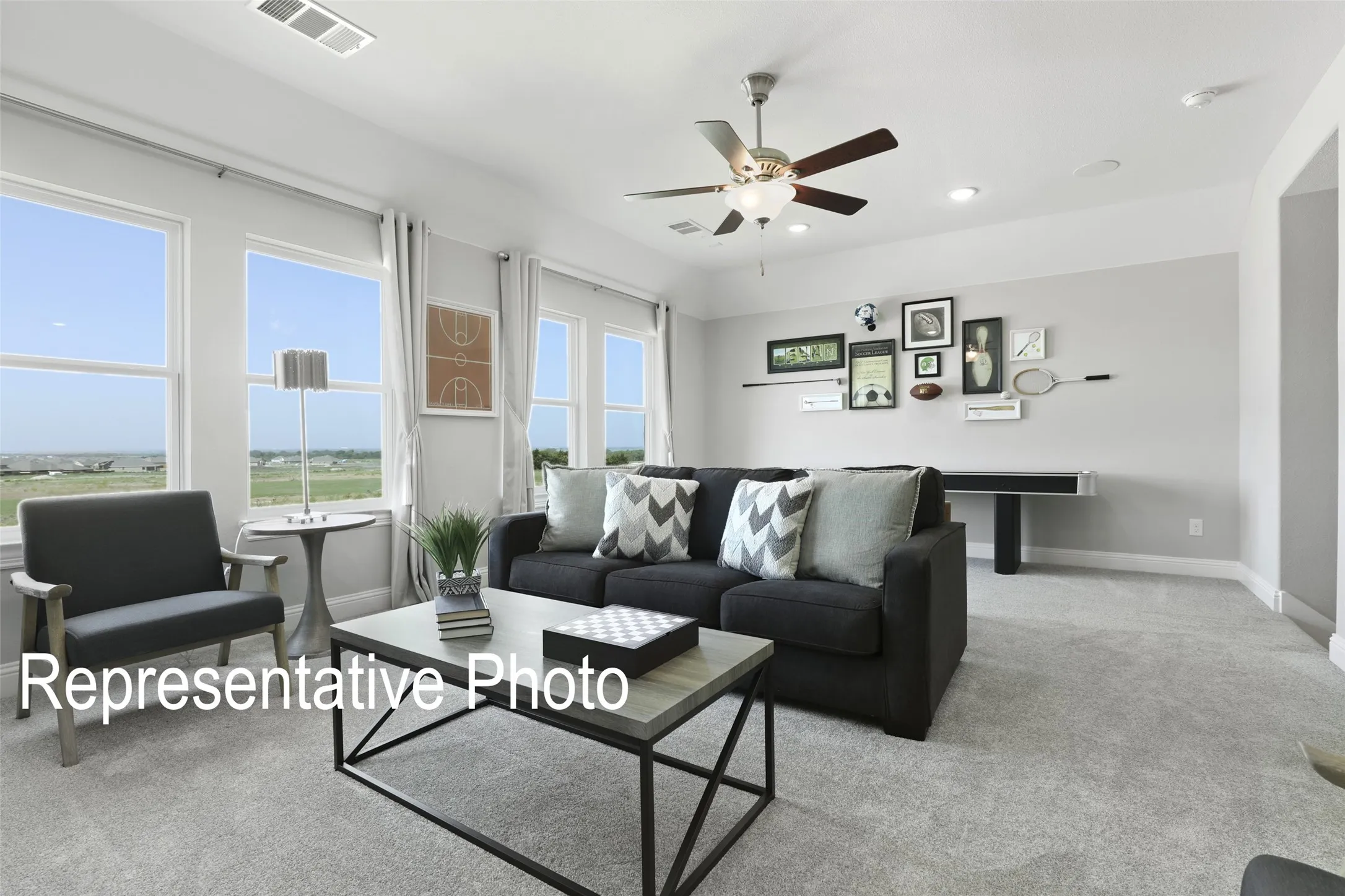 Light gray wall tones with white trim, recessed lighting, ceiling fan, and carpeted flooring