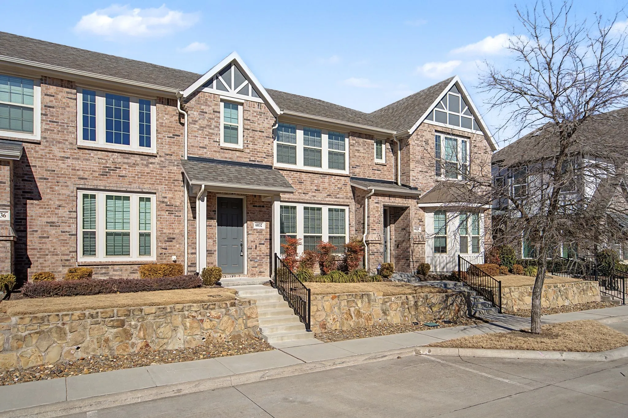 Brick exterior townhome with contrasting gables and white trim