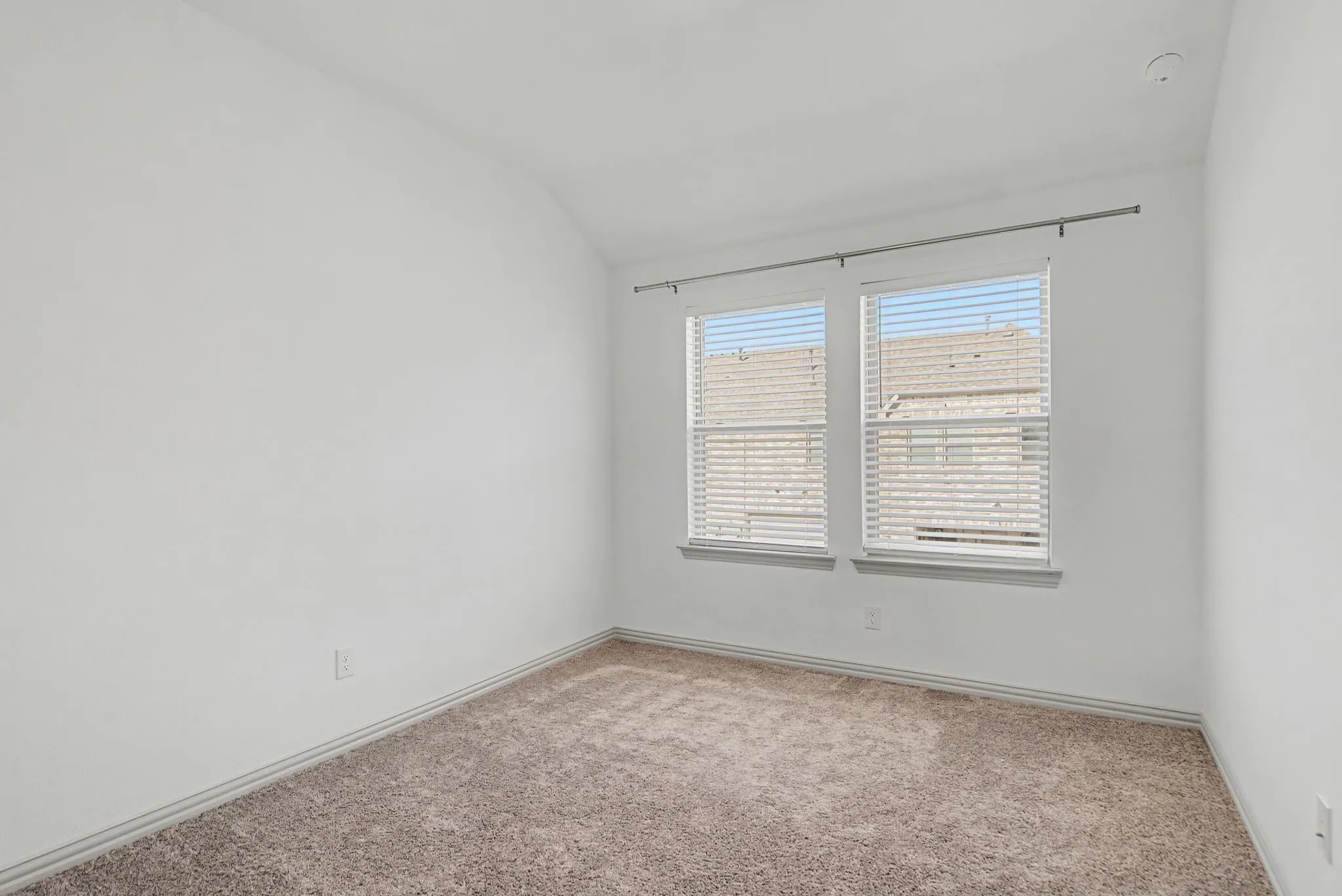 Neutral white walls, plush carpet flooring, and white trim