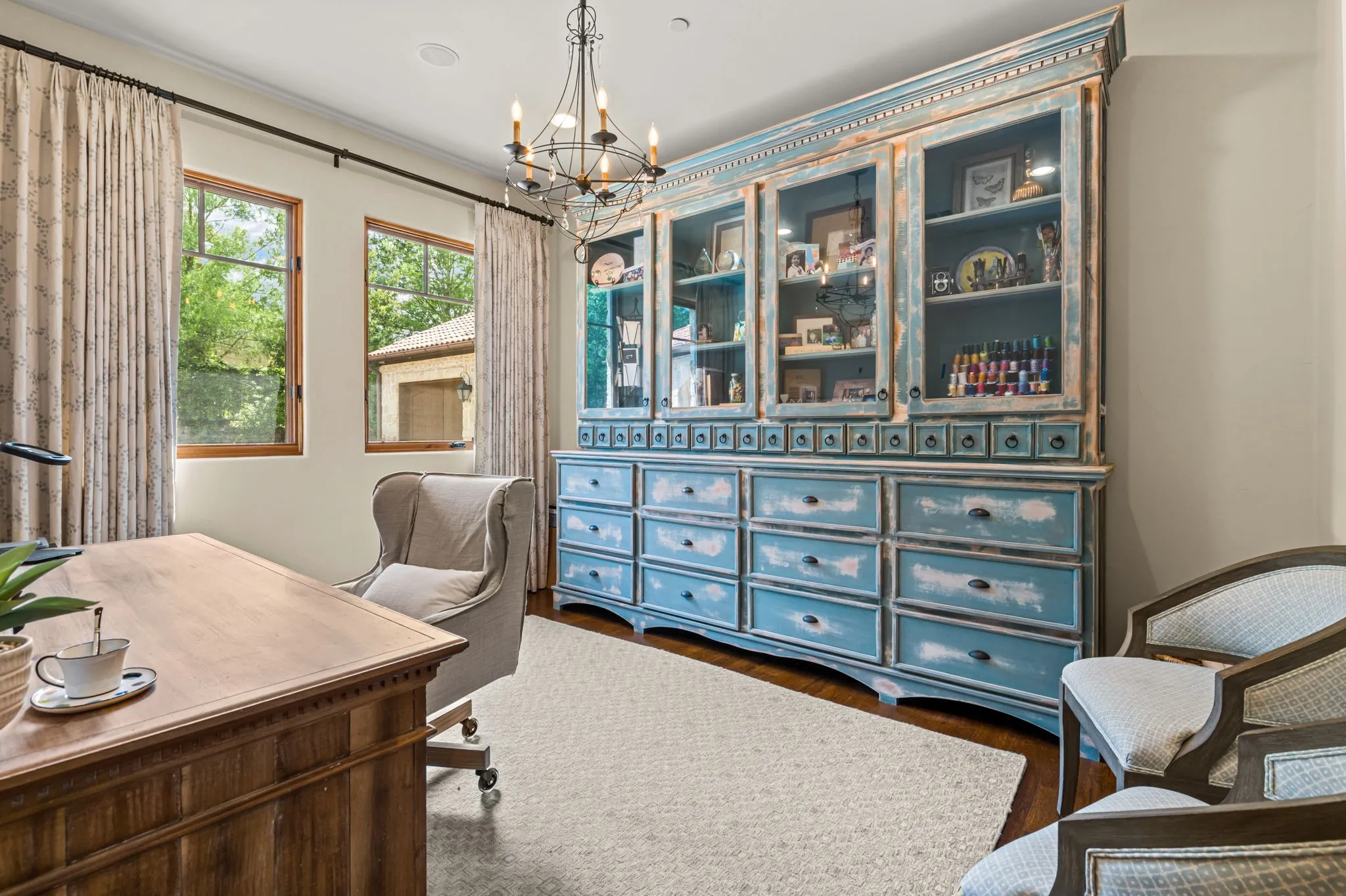 The second office is perfectly located behind the kitchen and has made an ideal art studio with the large windows. The custom hutch will convey