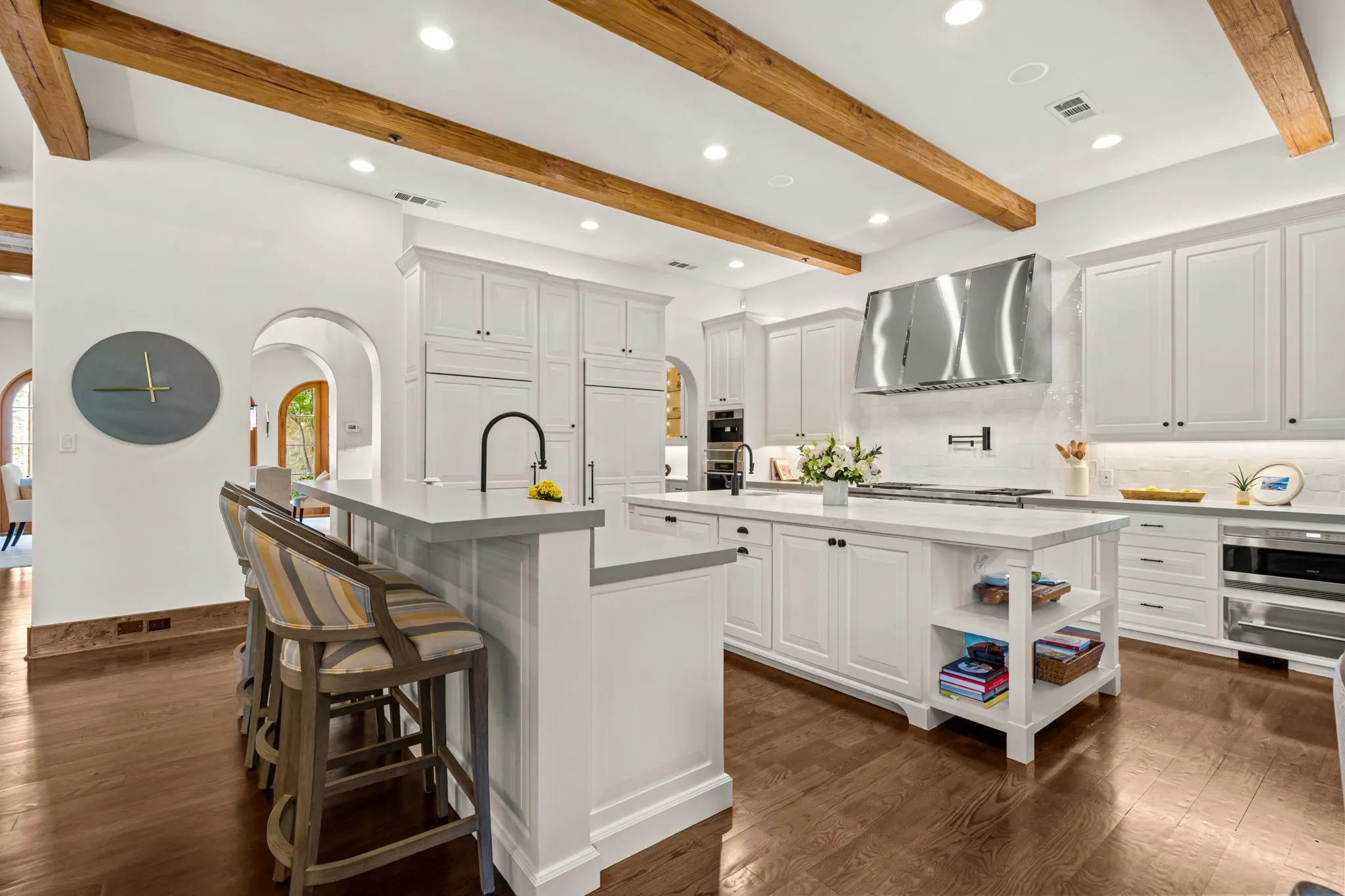 The kitchen was updated with Calcutta Marble and quartz counters, Zellige tile and a custom vent hood