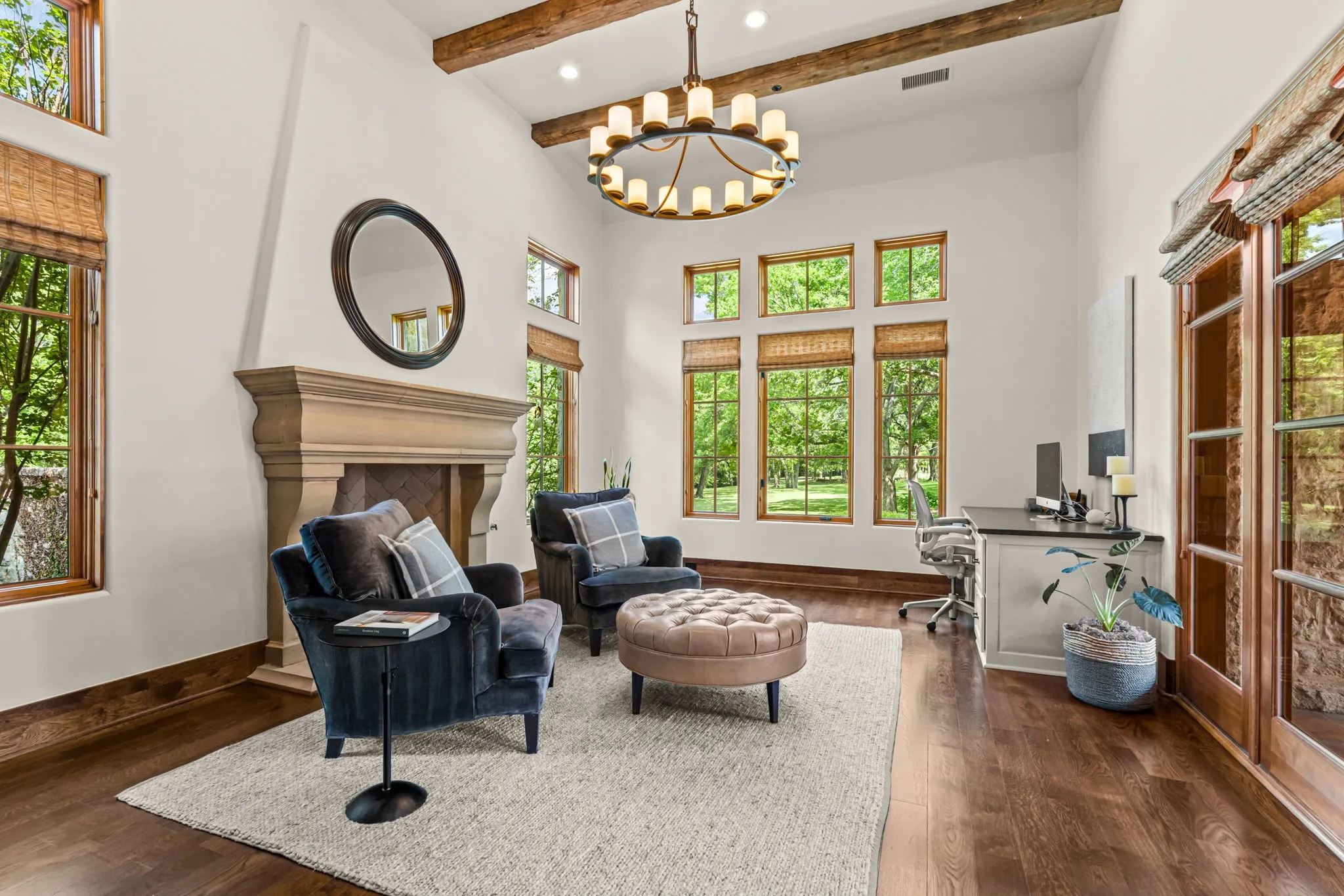 The formal office overlooks both the front courtyard and the primary wing courtyard - with a stately fireplace and bookshelves