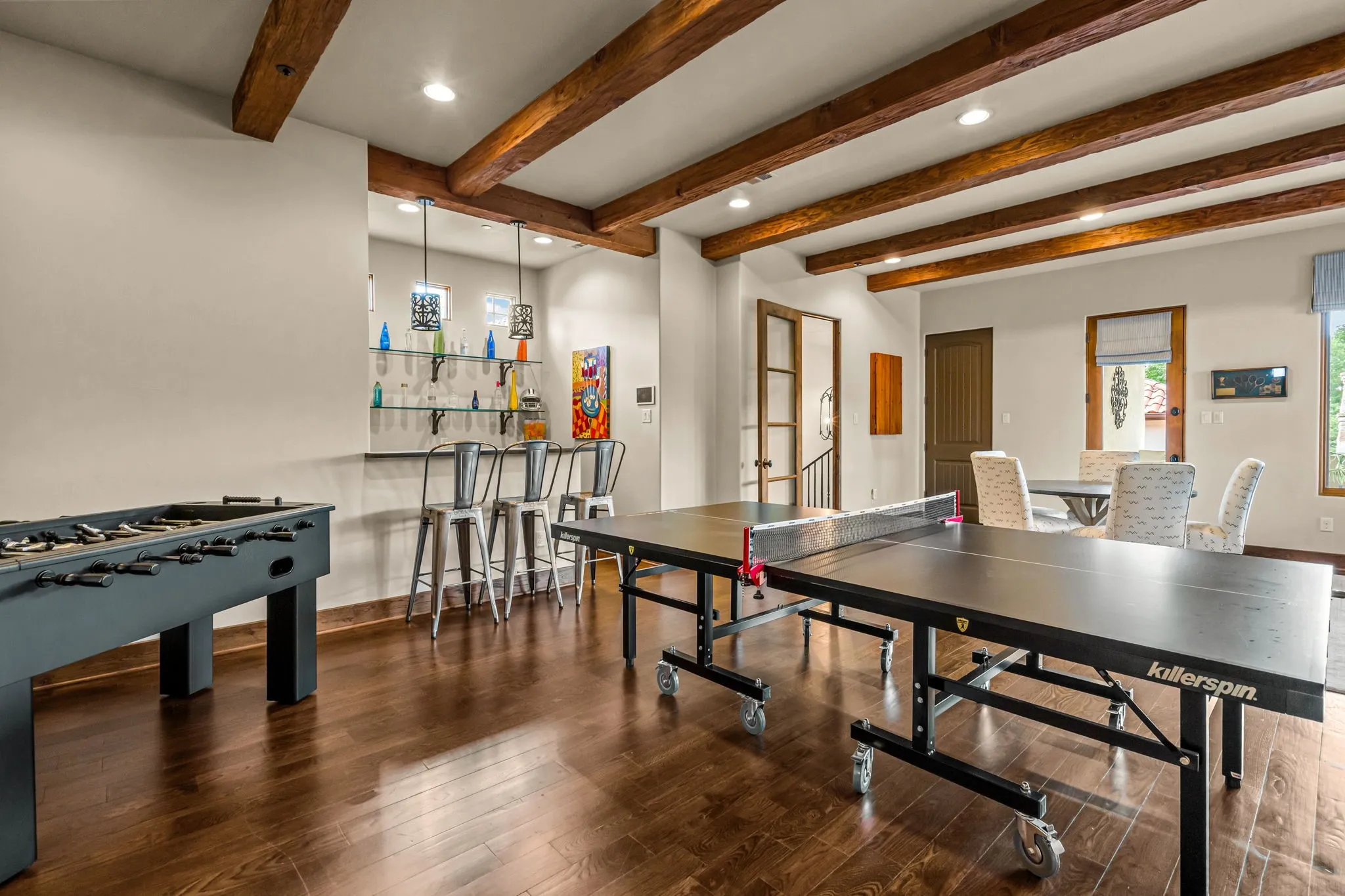 Second Floor game room with wet bar, hardwood floors and ceiling beams