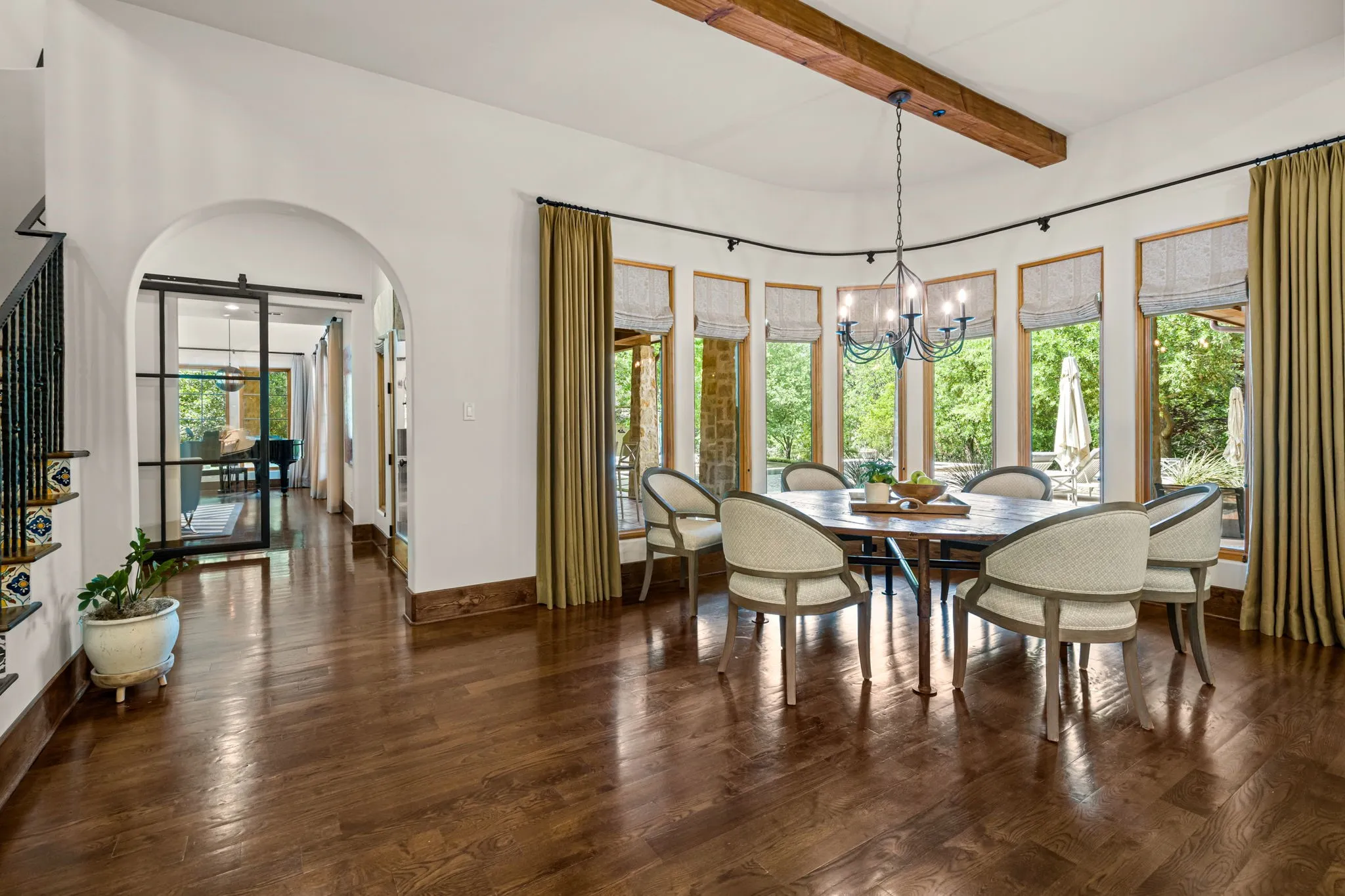A large casual dining area overlooking the pool and yard