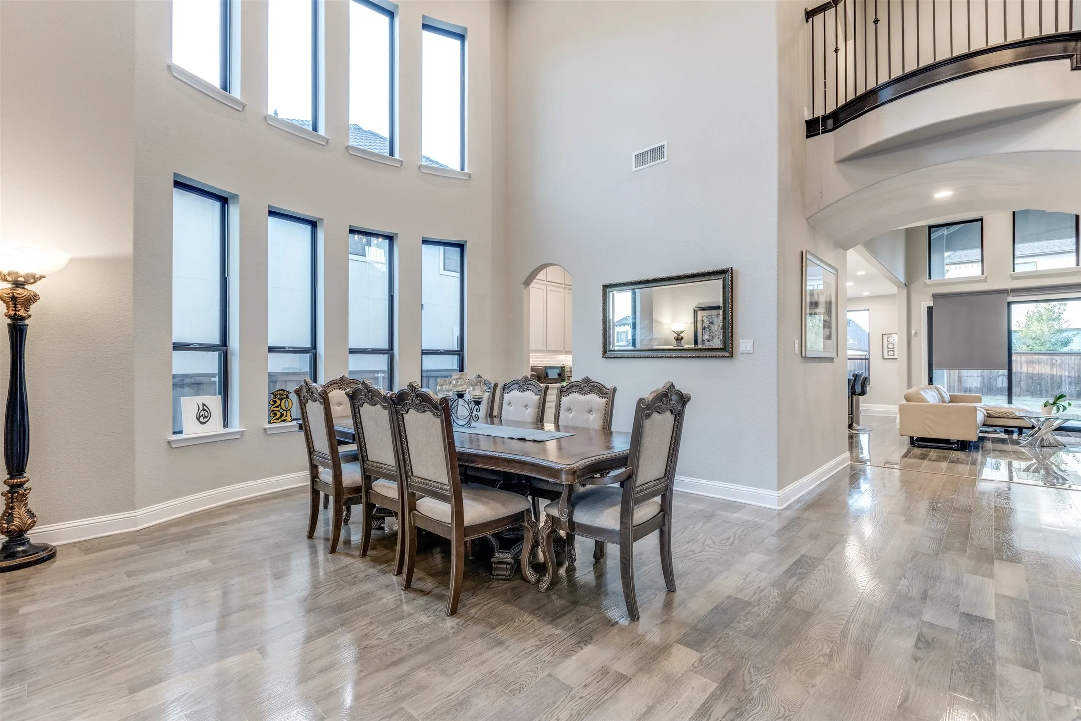 Two-story dining space featuring wood-finish flooring