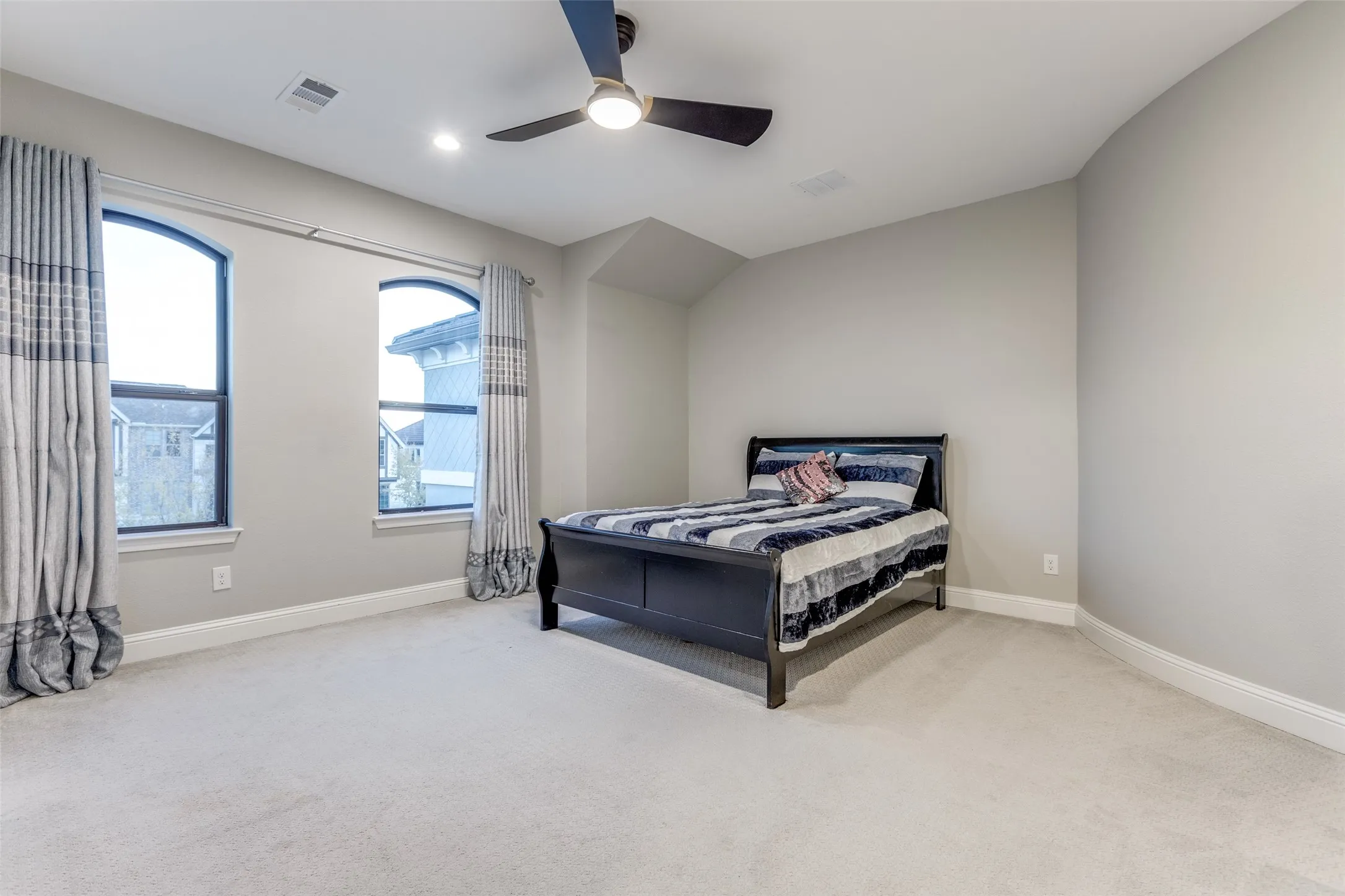 Spacious room featuring light-colored carpeting, recessed lighting, and a ceiling fan